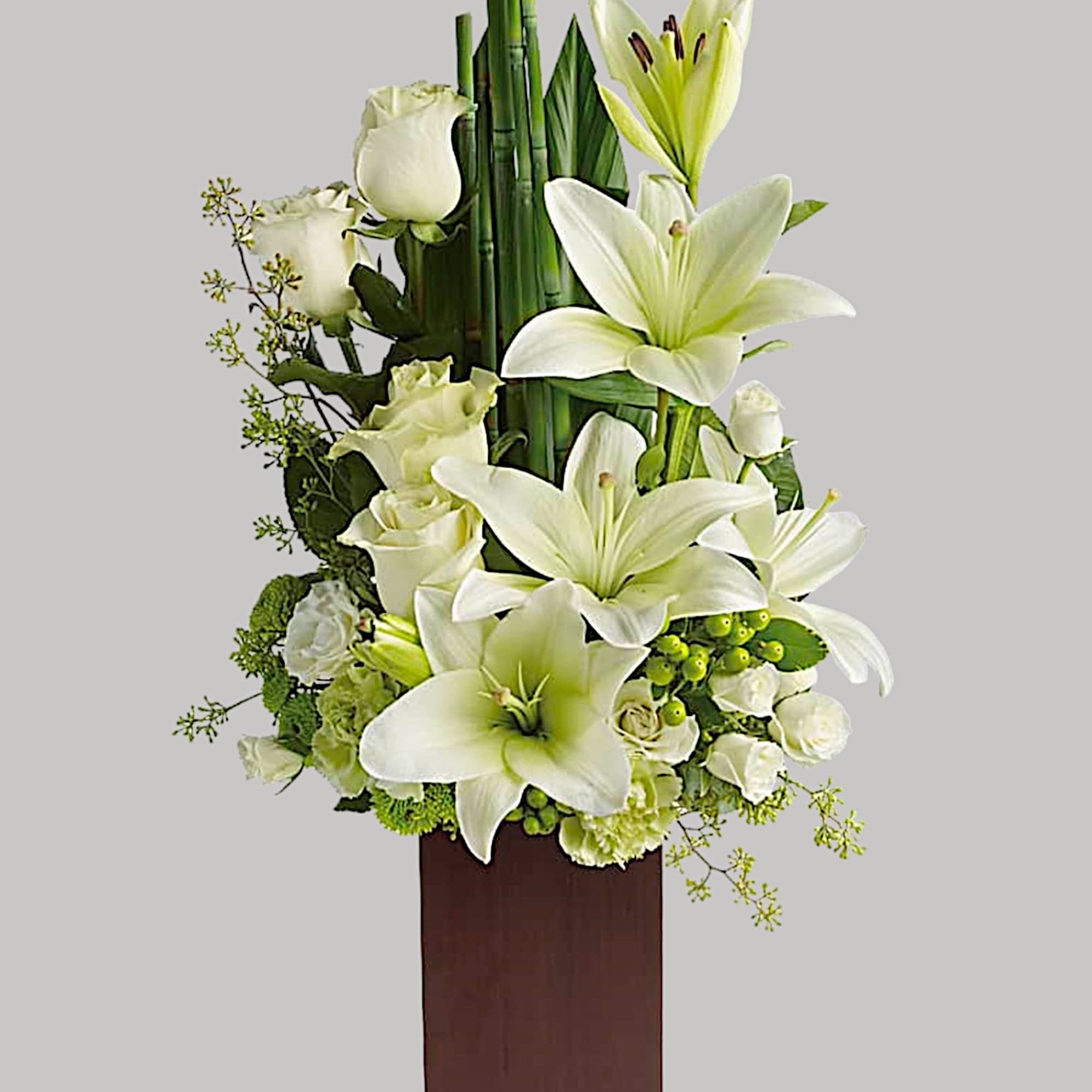 White lilies and roses arranged in a tall wooden vase, photo 3 of 3