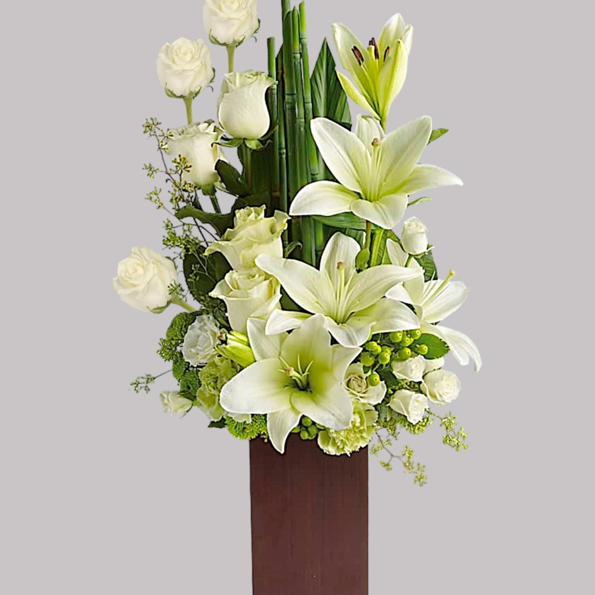 White lilies and roses arranged in a tall wooden vase, photo 3 of 3