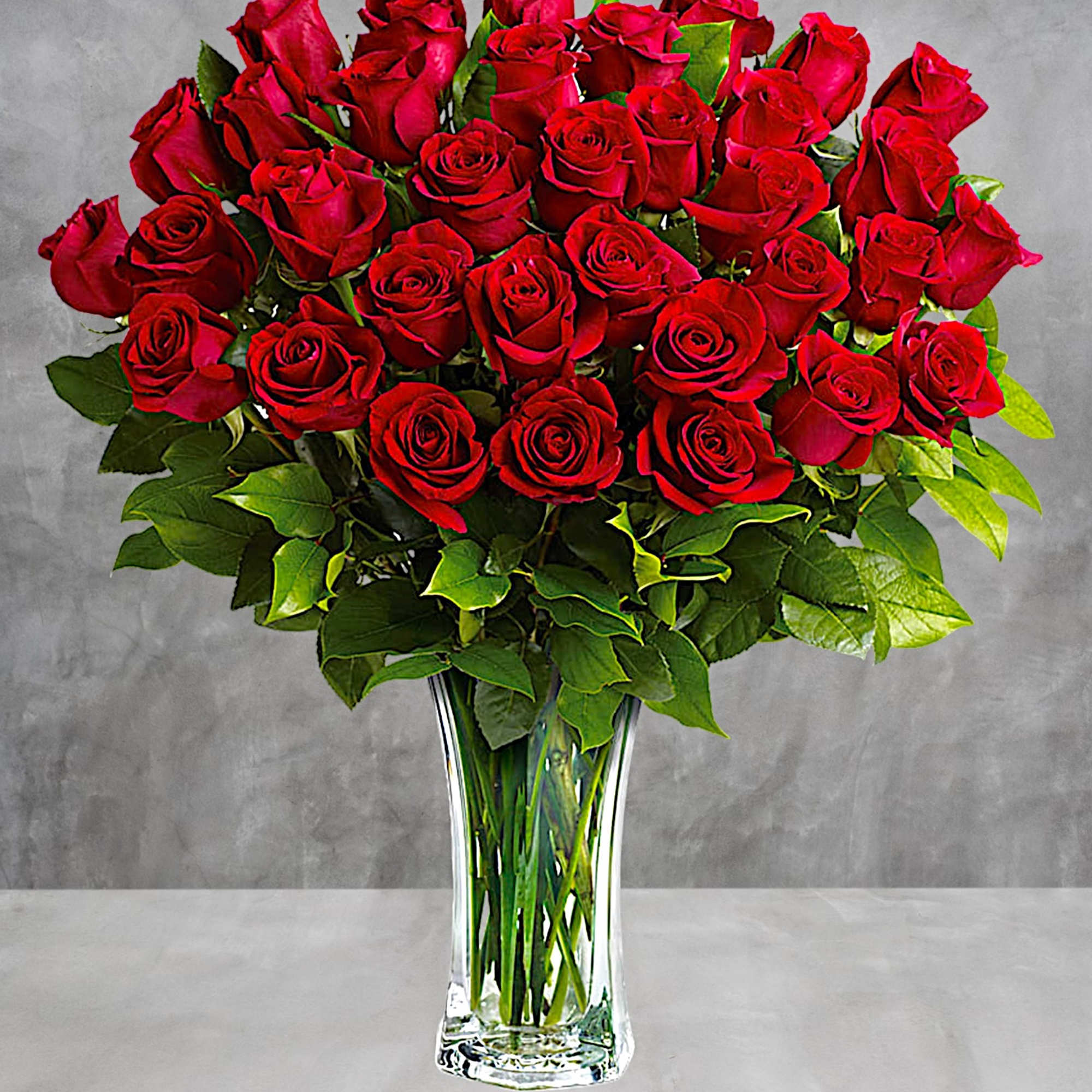 Bouquet of red roses in a clear glass vase, photo 2 of 3