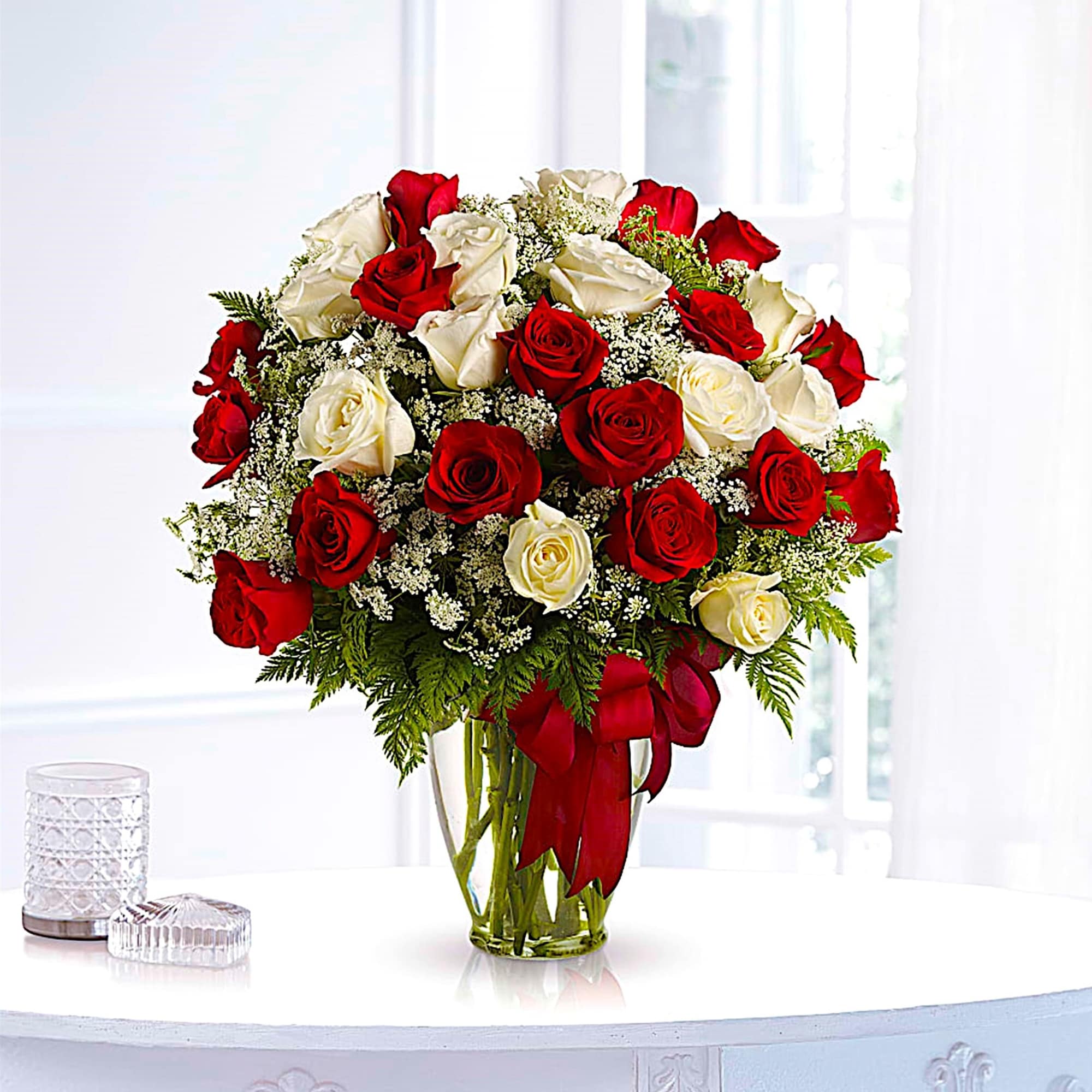Bouquet of red and white roses in a clear glass vase