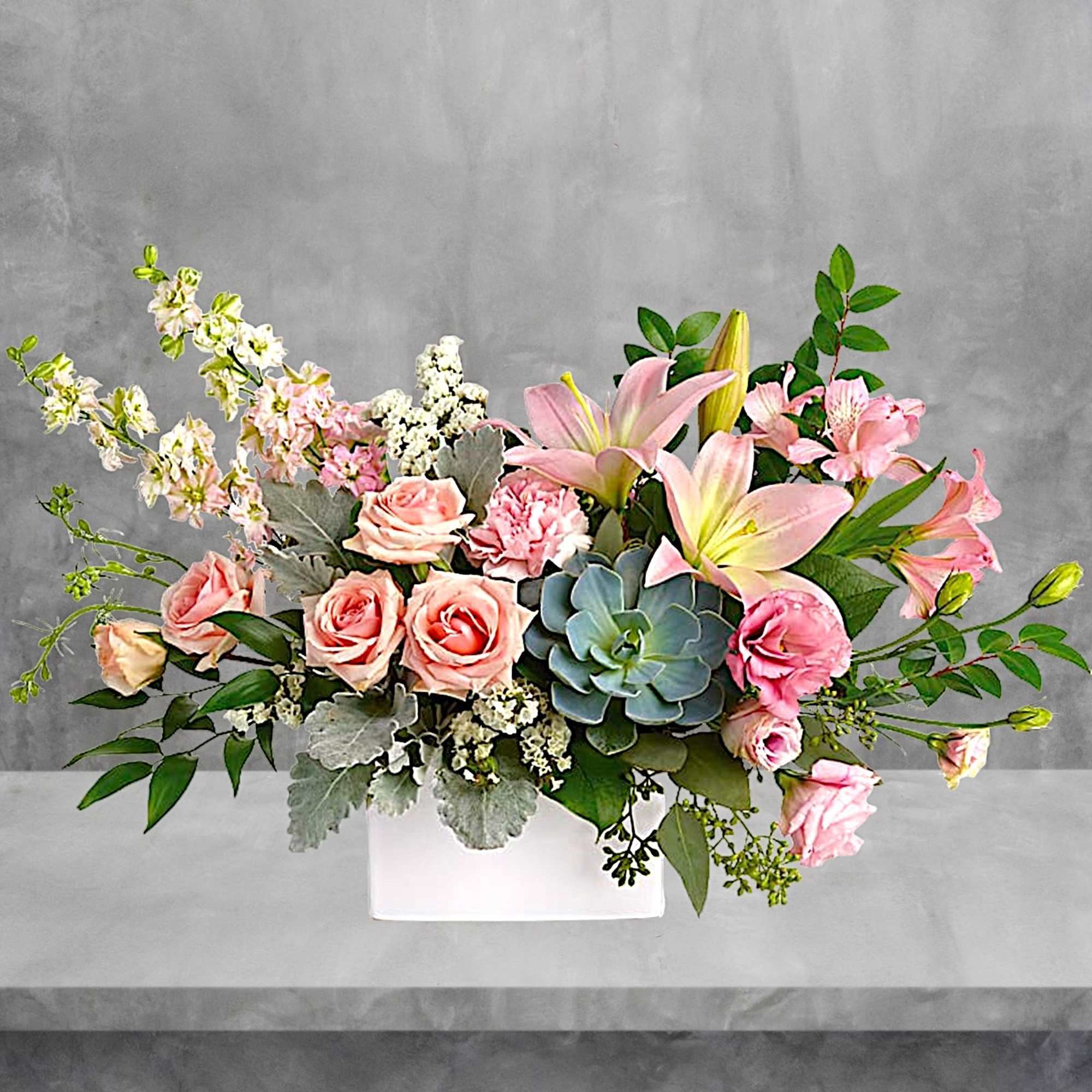 Pink roses and lilies arranged in a white rectangular vase, photo 2 of 6