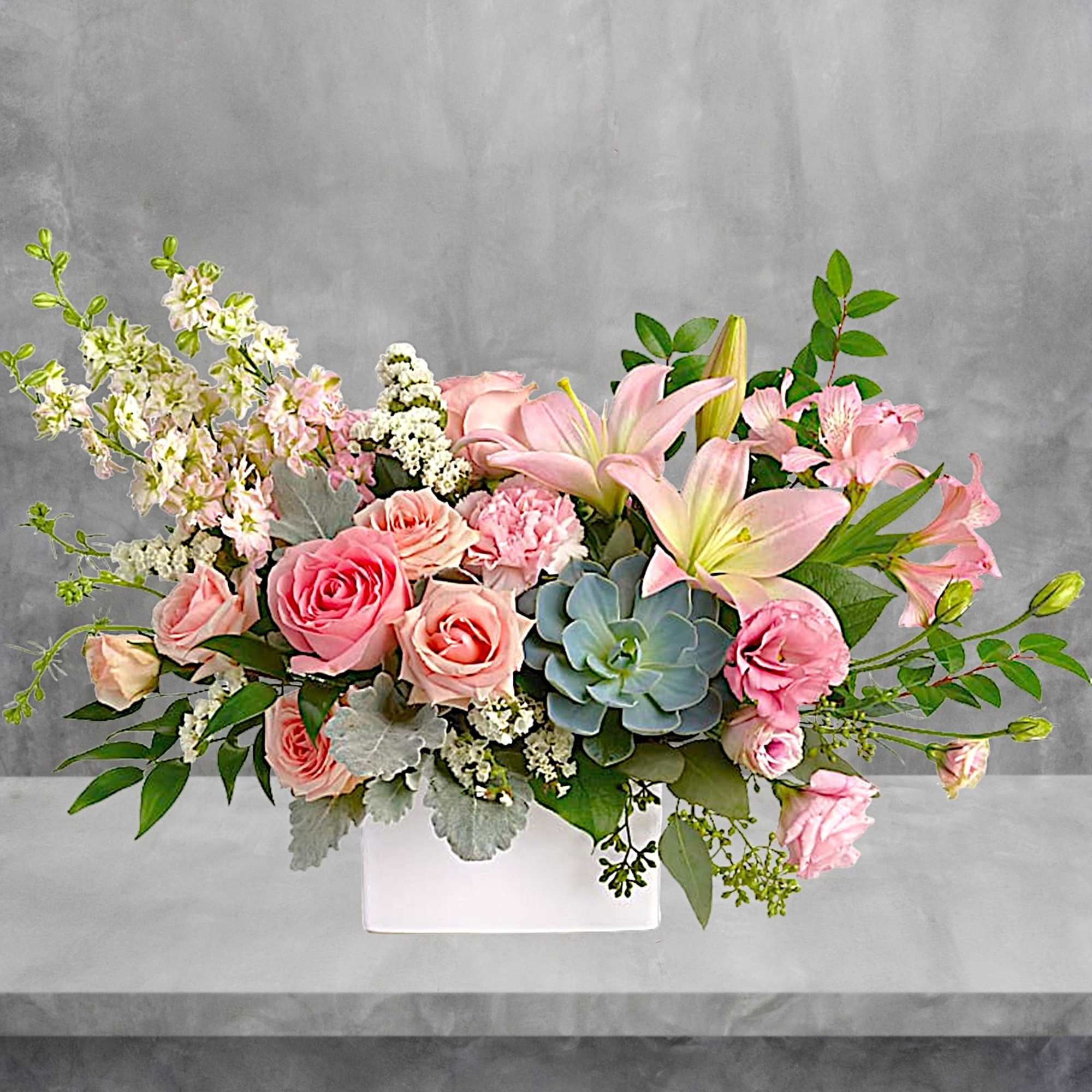 Pink roses and lilies arranged in a white rectangular vase, photo 2 of 6