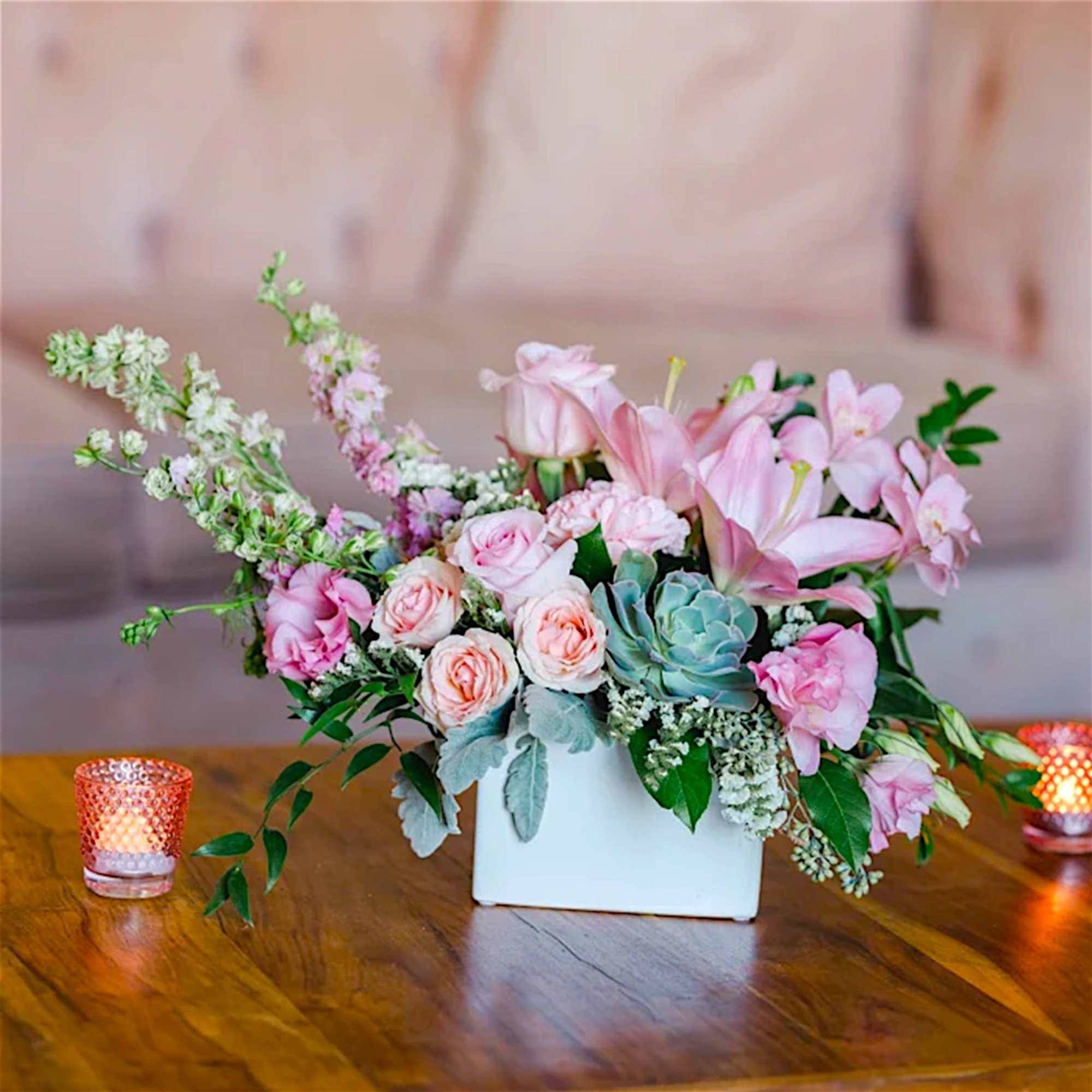 Pink and white floral arrangement in a white rectangular vase