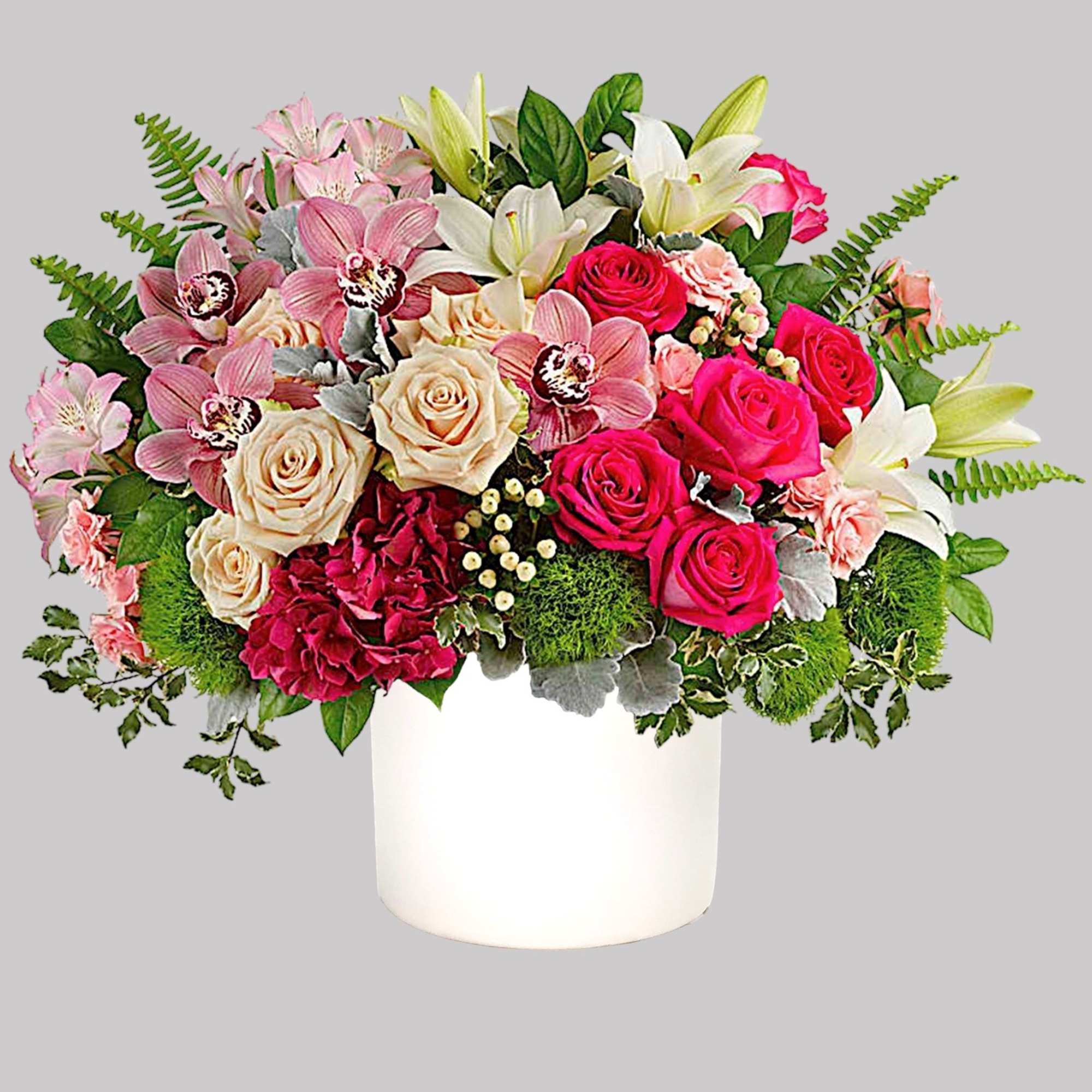 Mixed bouquet of roses, lilies, orchids, and carnations in a white vase
