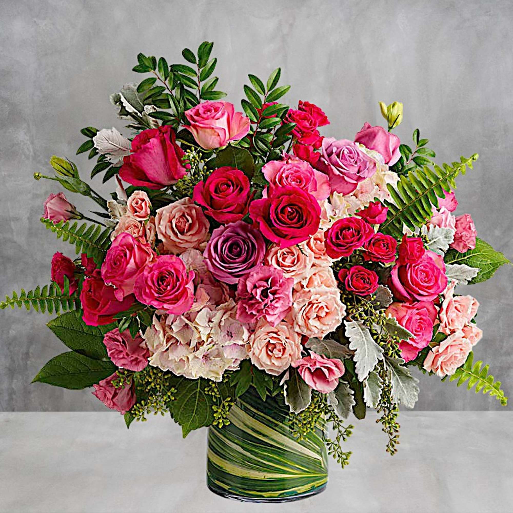 Bouquet of pink and peach roses in a green-striped glass vase, photo 2 of 3