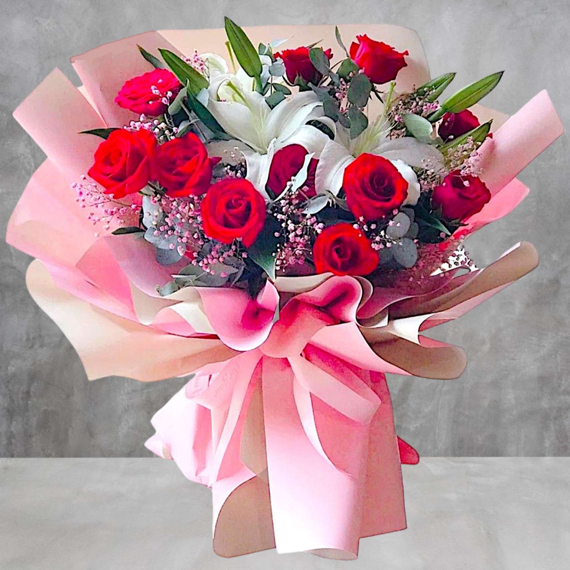 Bouquet of red roses and white lilies wrapped in pink paper, photo 3 of 4