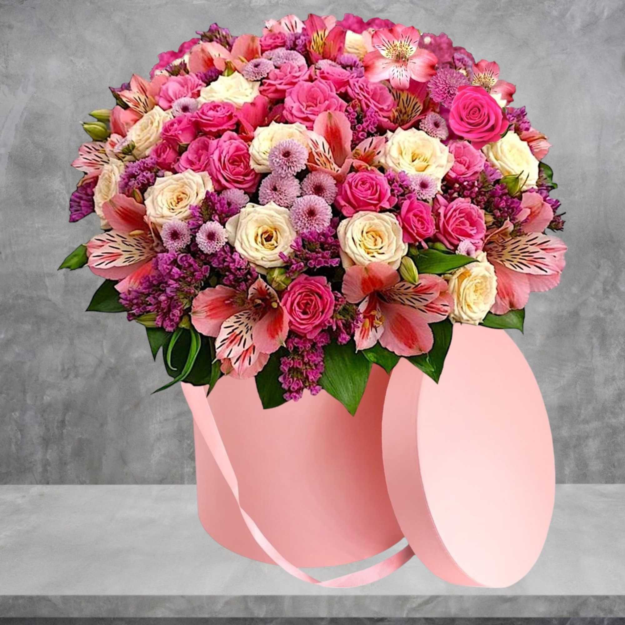 Pink and cream rose bouquet in a round pink hatbox with ribbon