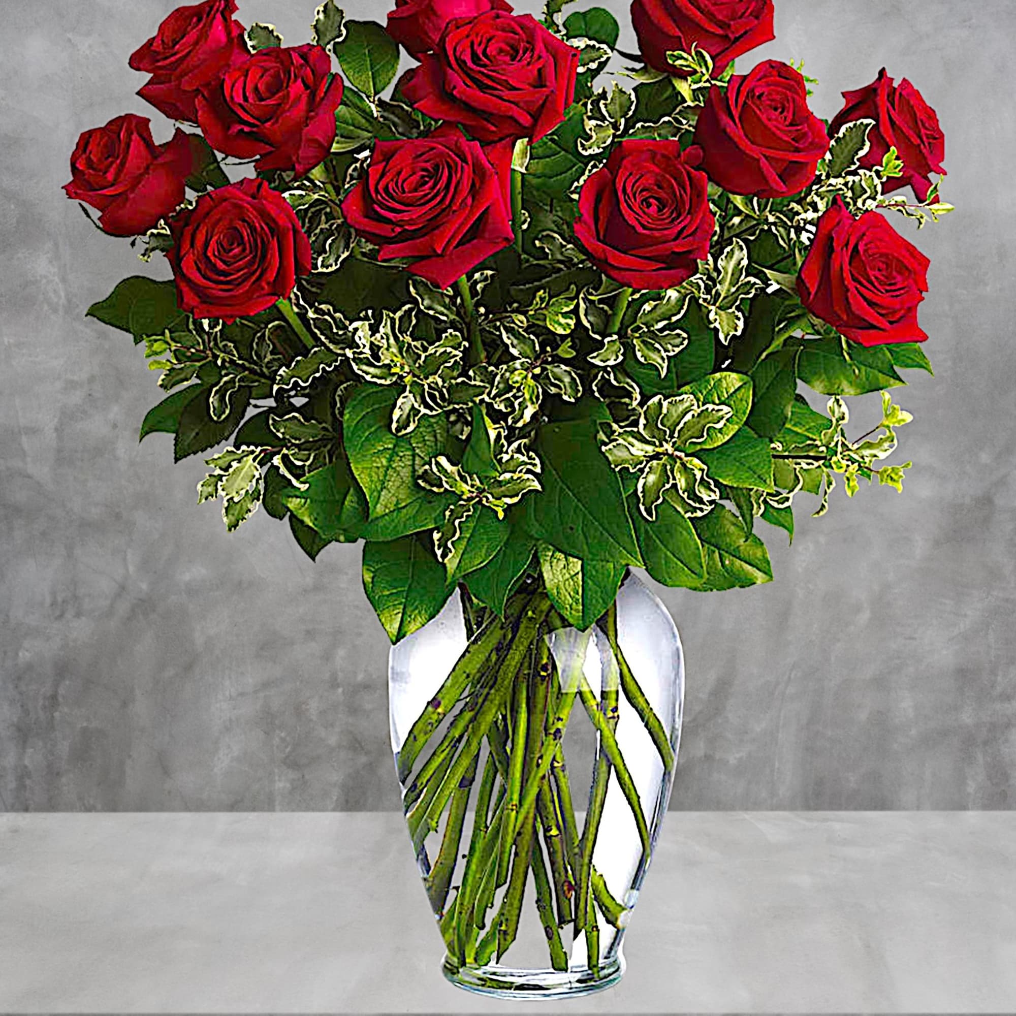 Red roses arranged in a clear glass vase