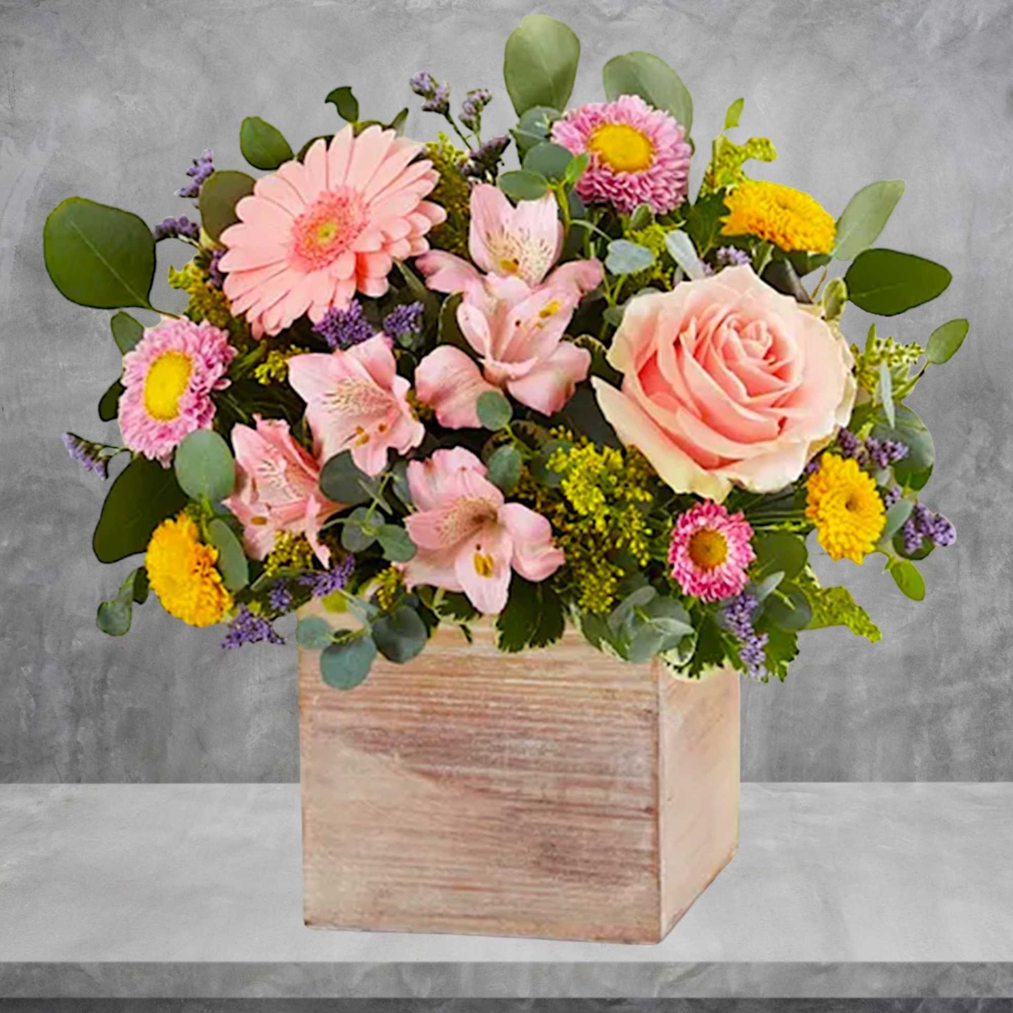 Mixed pink and yellow flowers in a wooden box, photo 2 of 6
