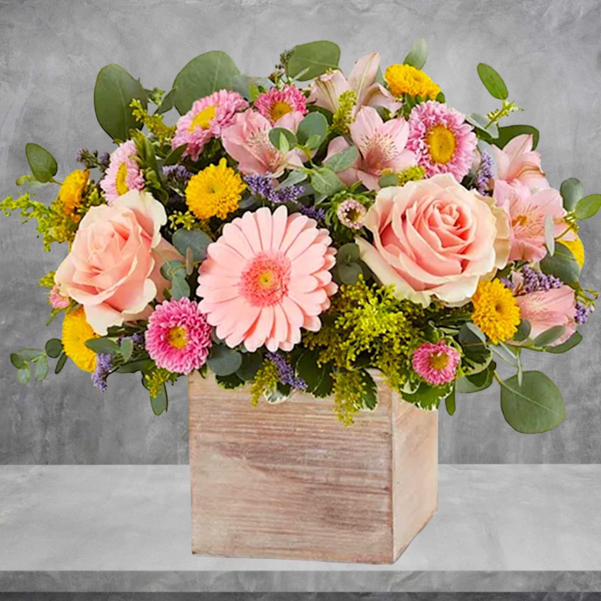 Pink and yellow mixed flower arrangement in a wooden box, photo 2 of 6