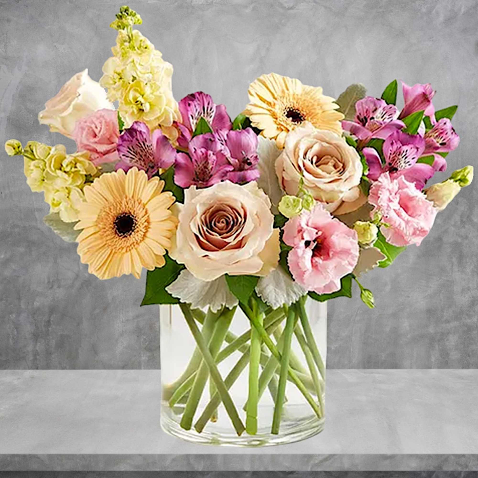 Mixed pink and cream flowers arranged in a clear glass vase, photo 2 of 6