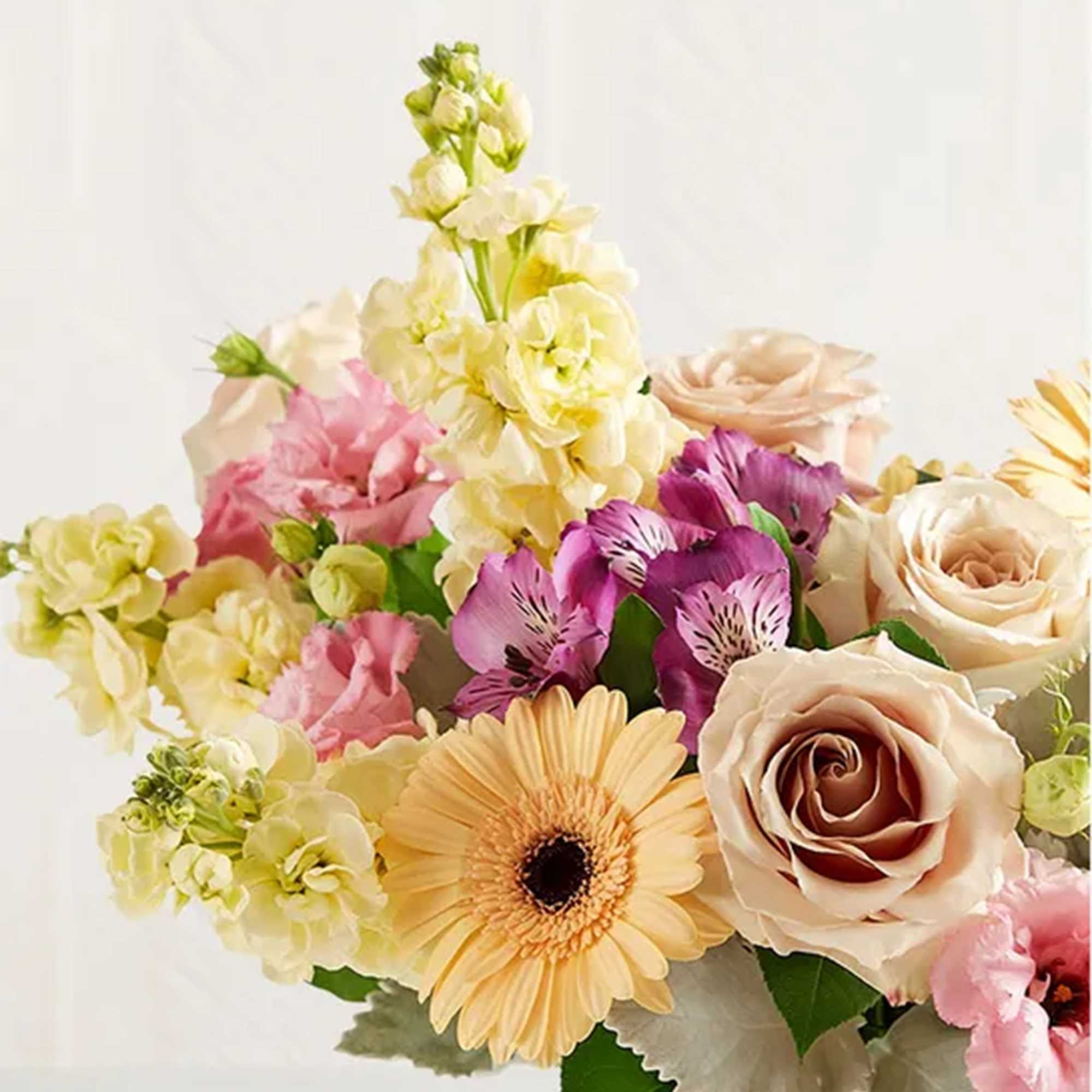 Bouquet of pastel roses, alstroemeria, and a gerbera daisy