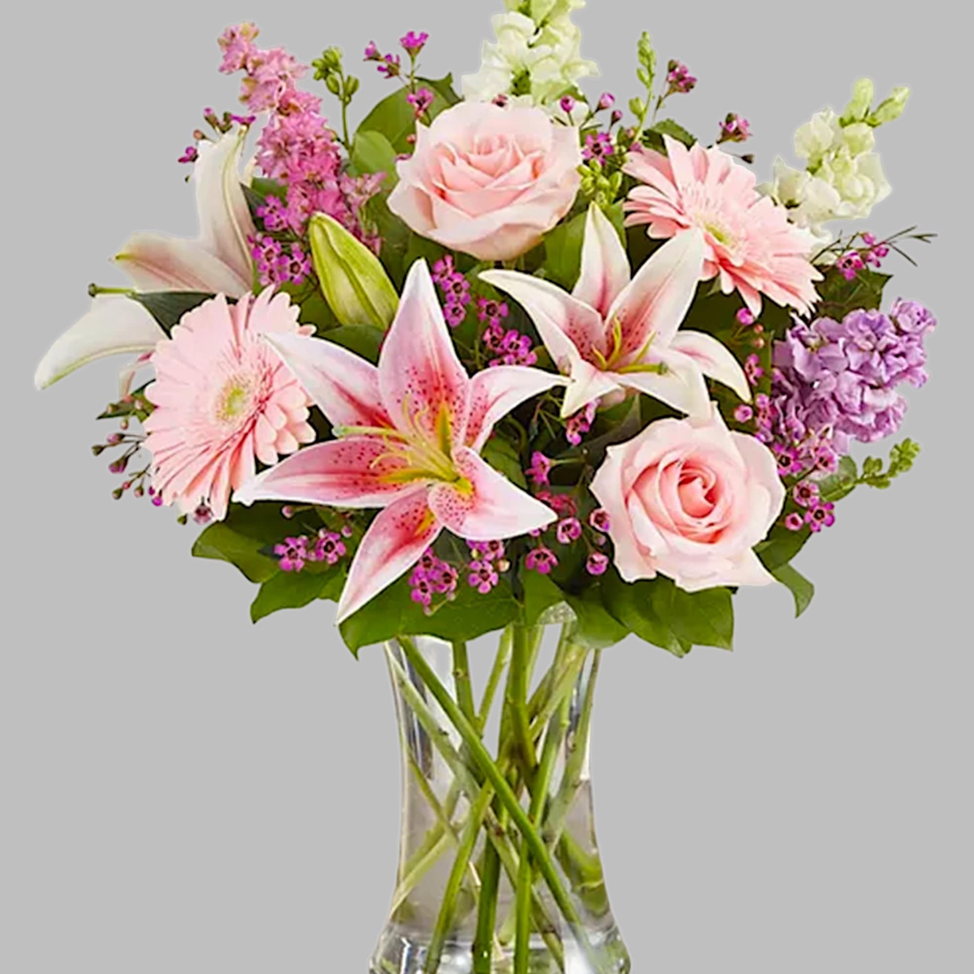 Pink roses and lilies arranged in a clear glass vase, photo 6 of 6