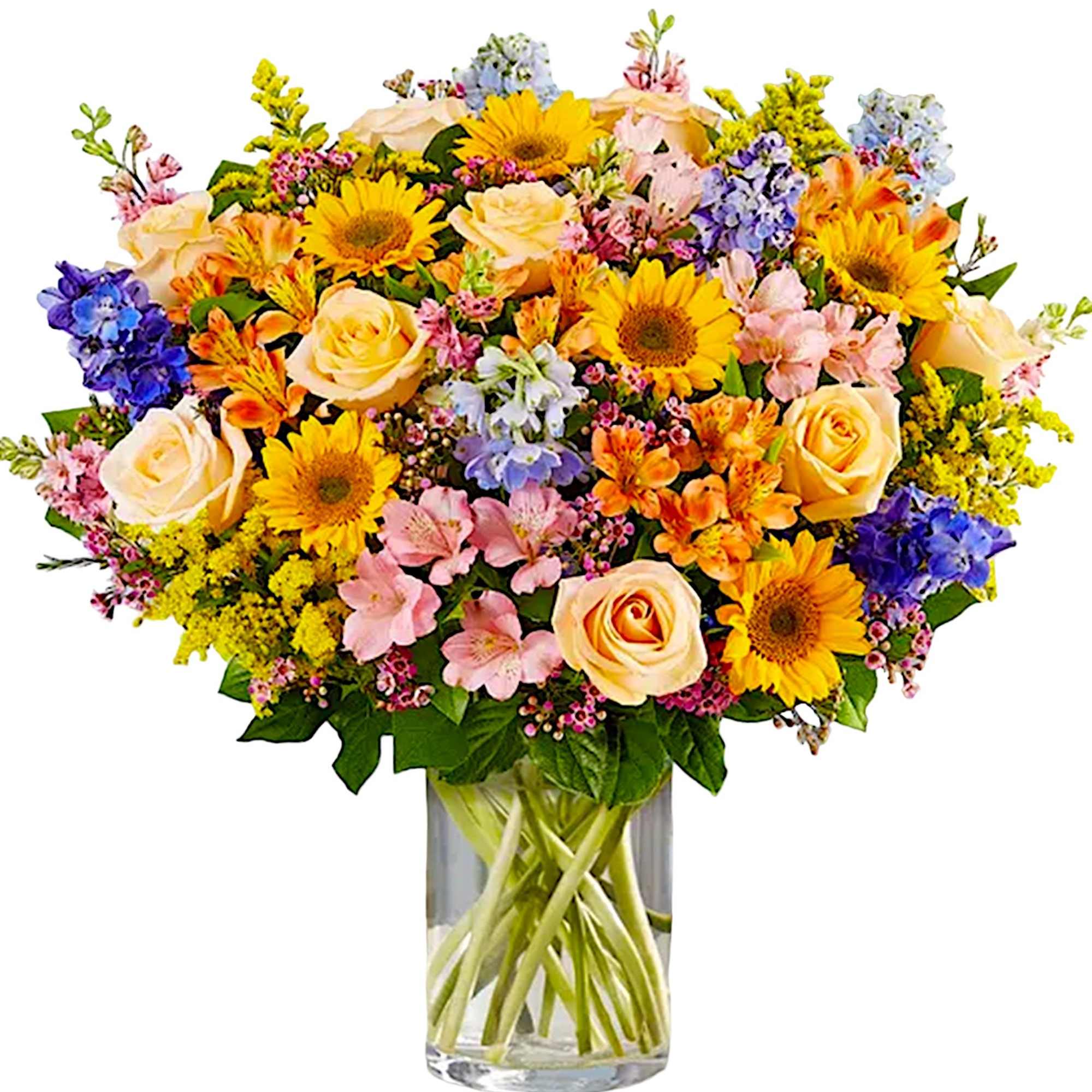 Mixed bouquet of yellow sunflowers, peach roses, and colorful blooms in a glass vase