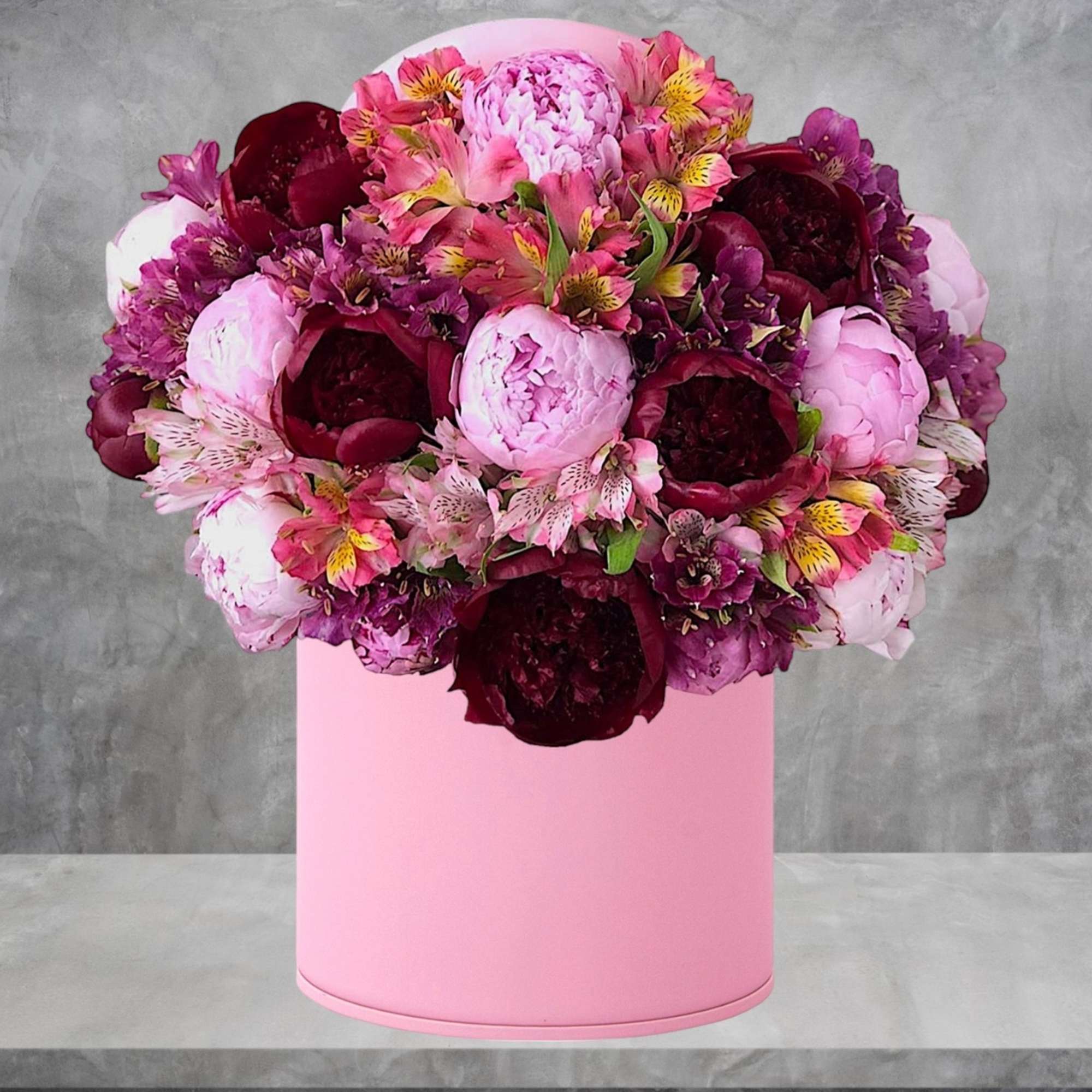 Pink and burgundy flower arrangement in a pink cylindrical box, photo 2 of 4