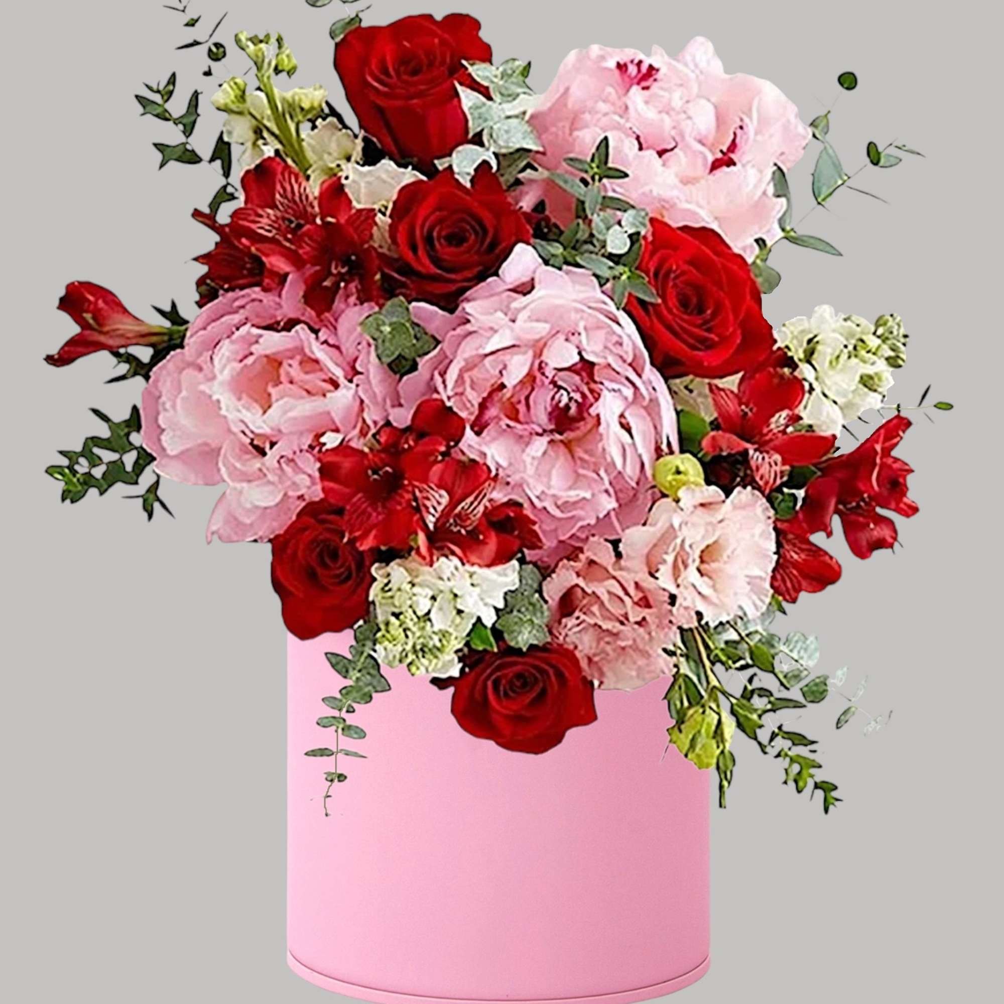 Pink and red floral arrangement in a pink cylindrical box, photo 3 of 4
