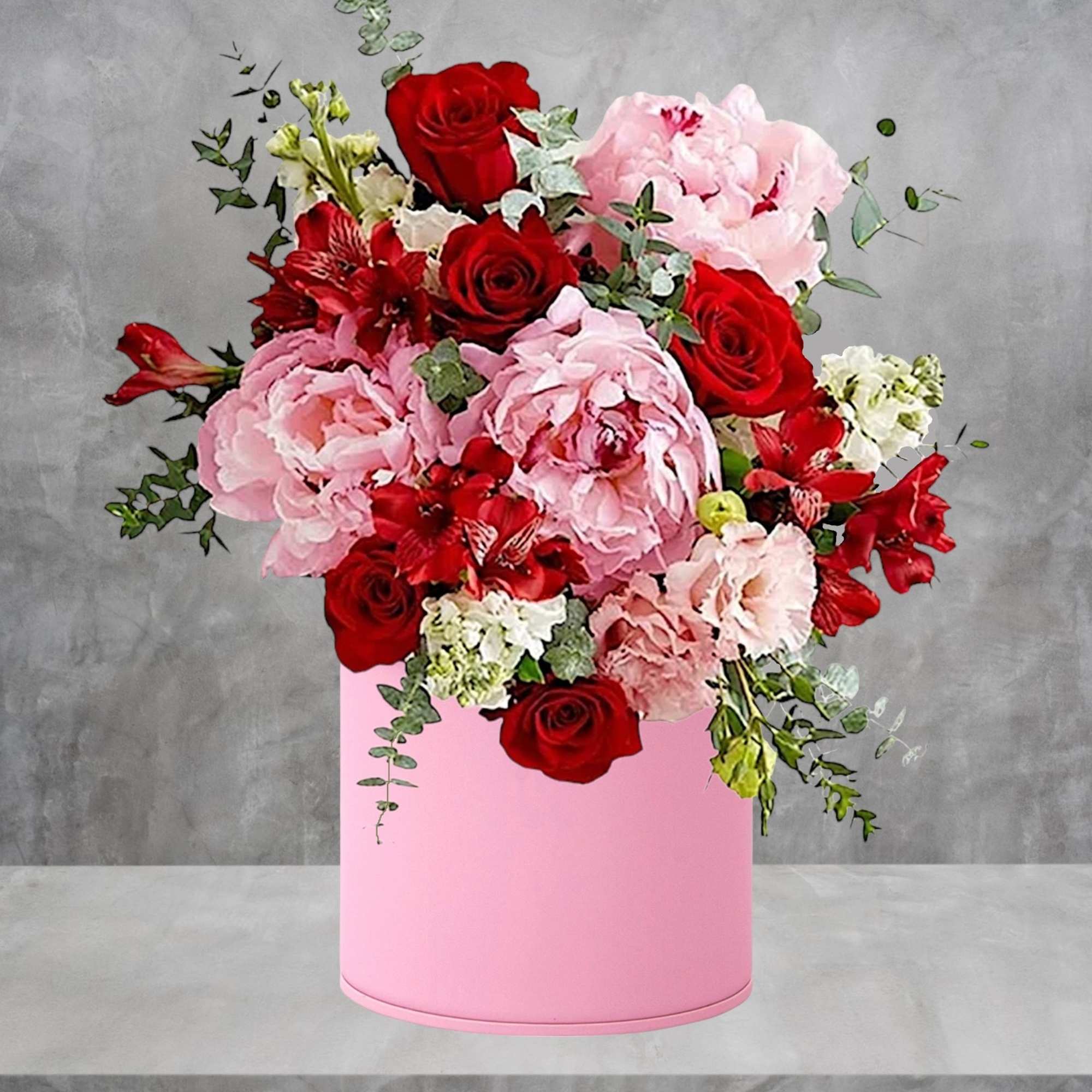 Pink and red floral arrangement in a pink cylindrical box, photo 2 of 4