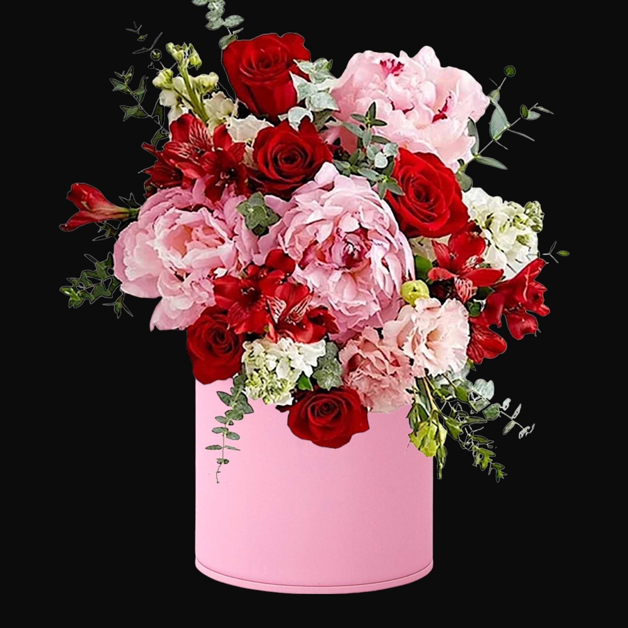 Pink and red mixed flower arrangement in a pink hat box