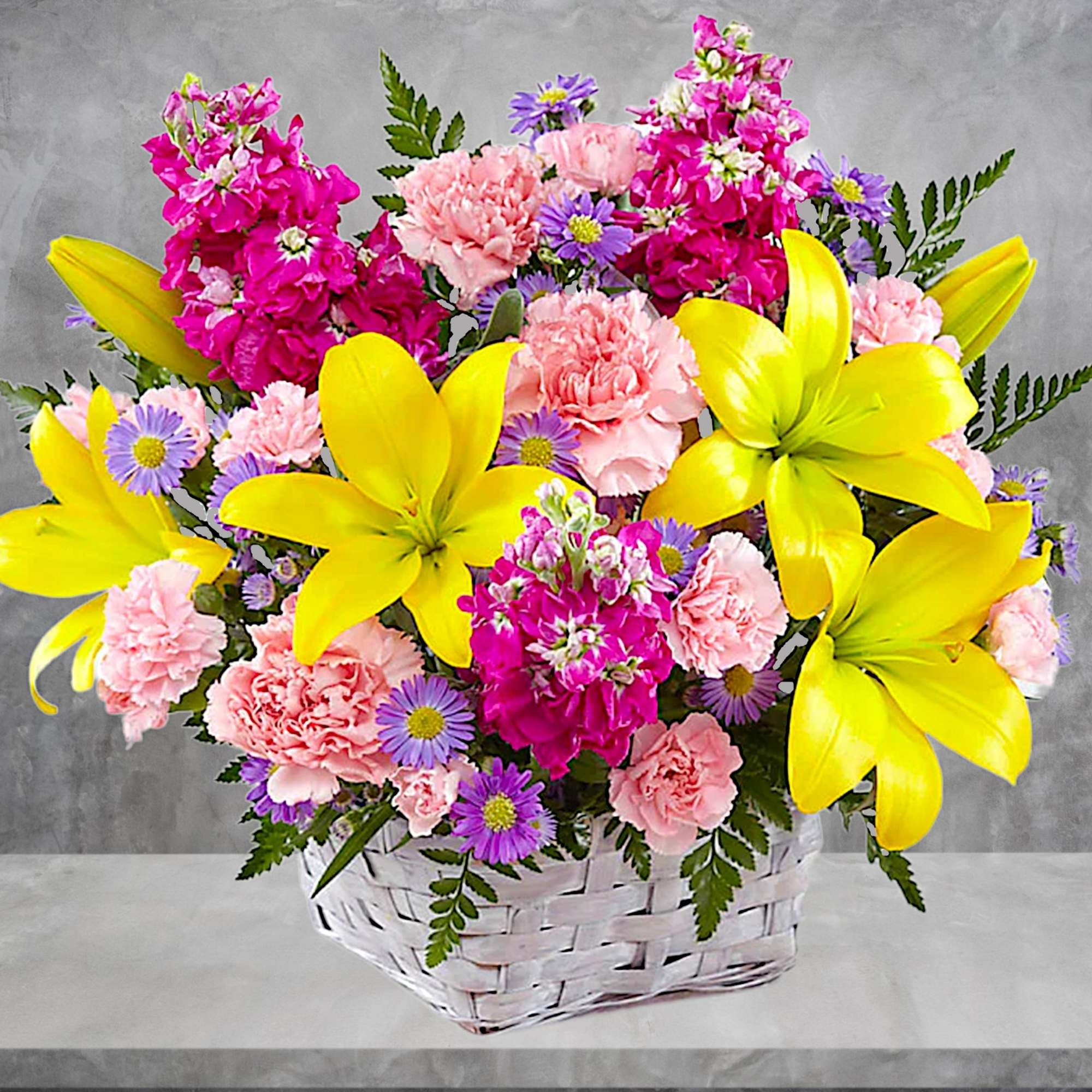 Basket of yellow lilies, pink carnations, and purple daisies, photo 2 of 4