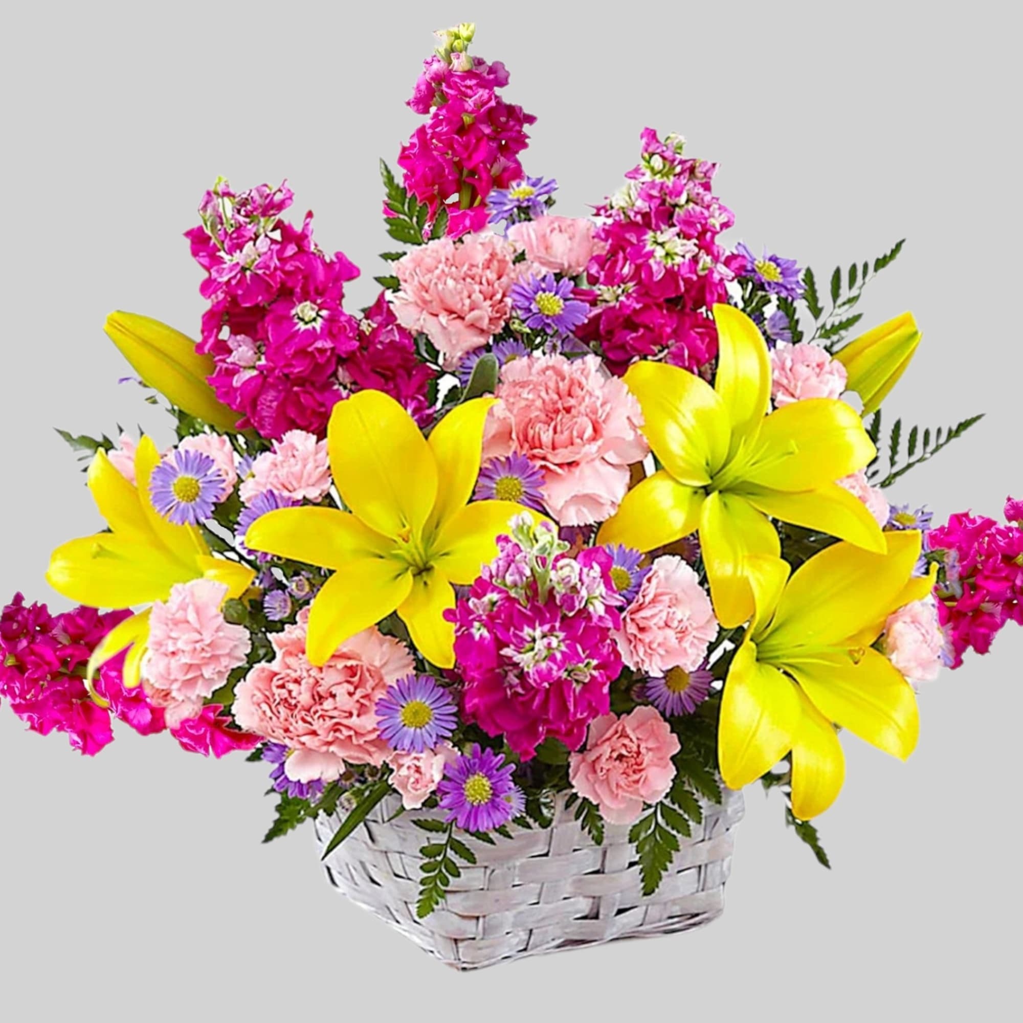 Basket of yellow lilies, pink carnations, and purple daisies