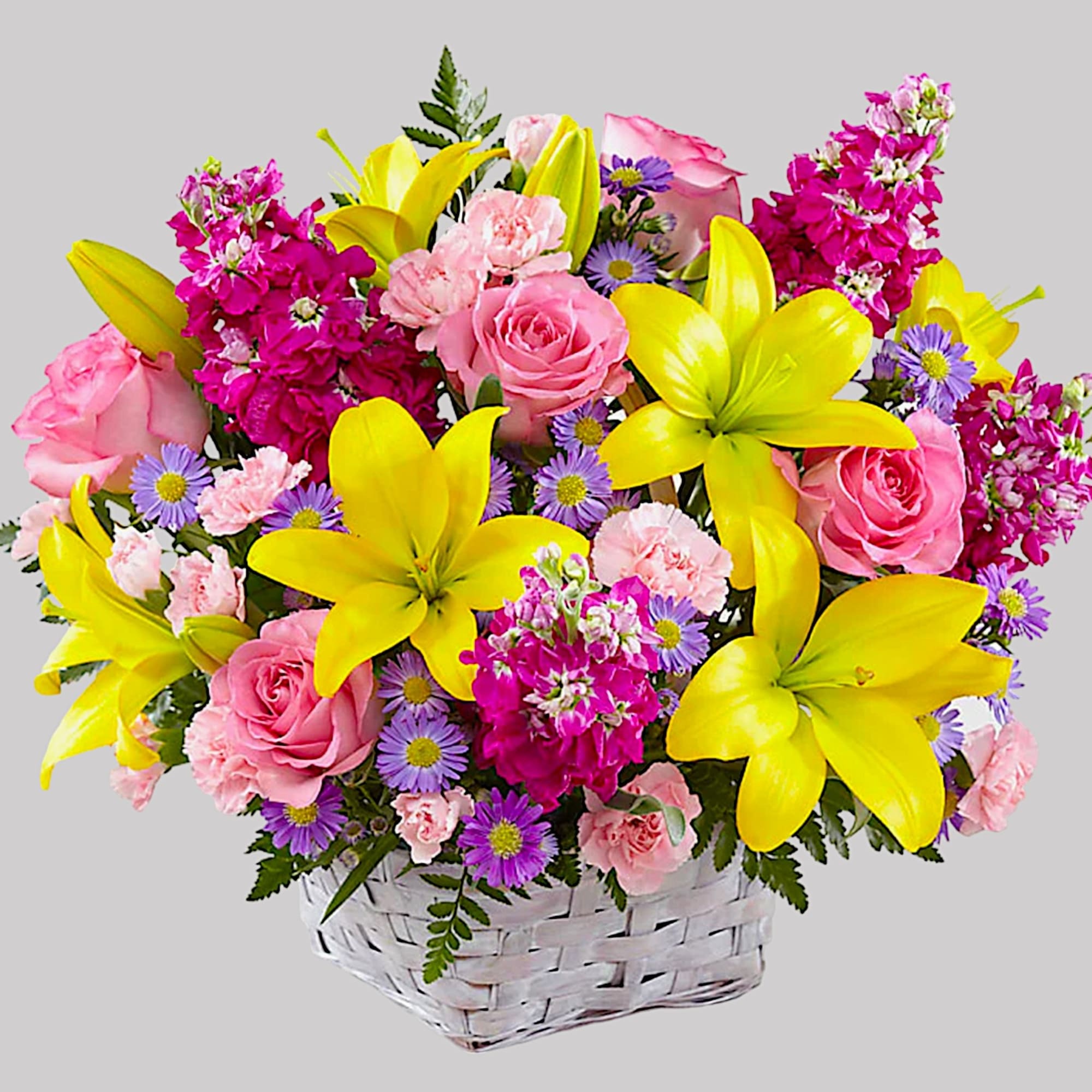 Pink roses, yellow lilies, and purple daisies in a white basket