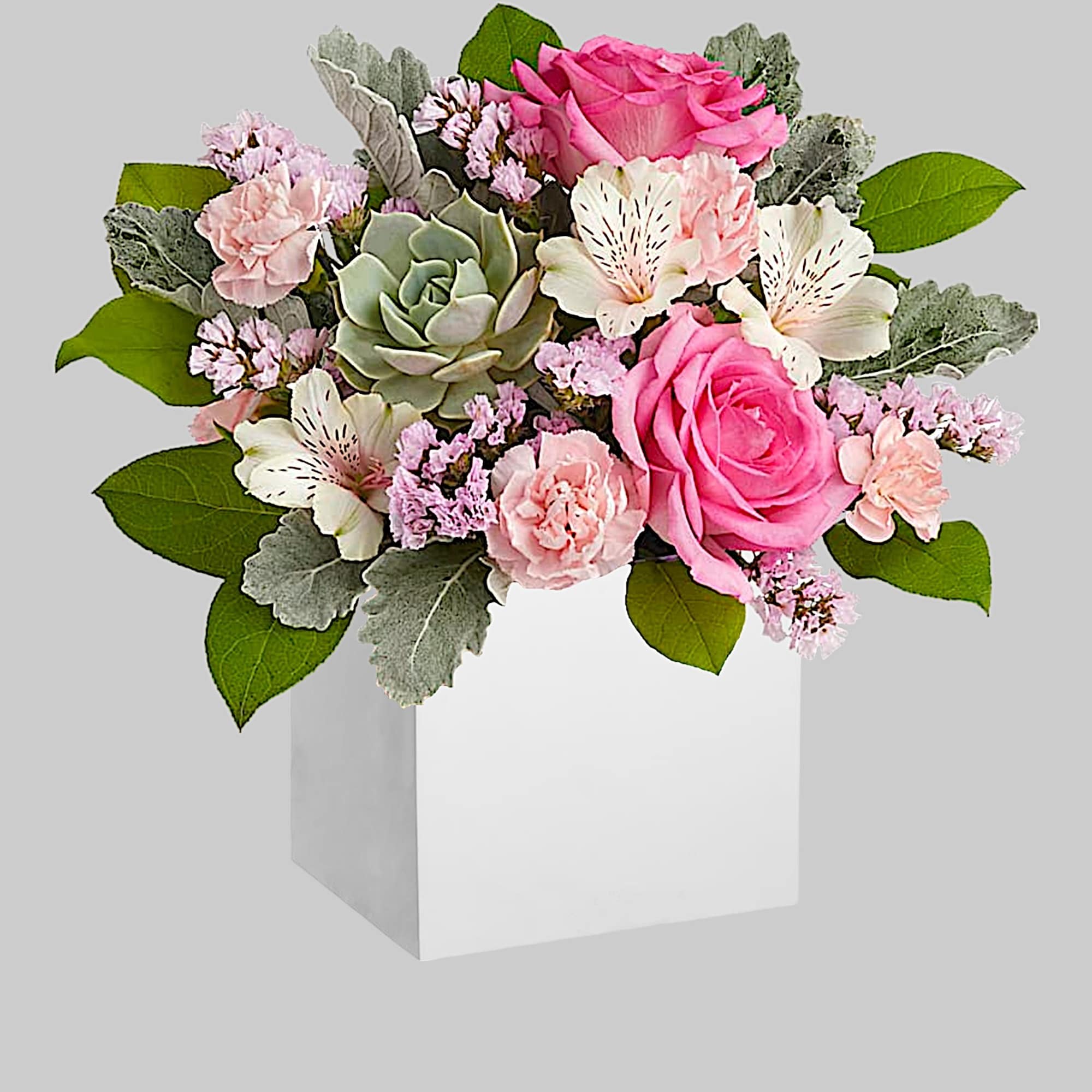 Pink and white floral arrangement in a white box vase