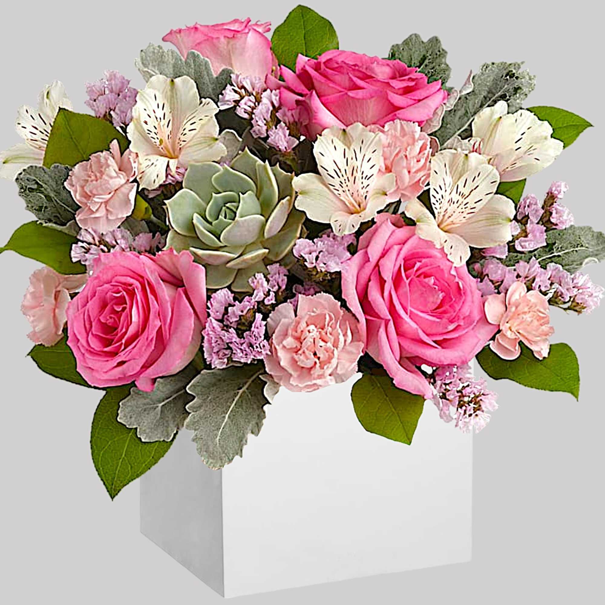 Pink roses and white alstroemeria in a white box with a succulent center