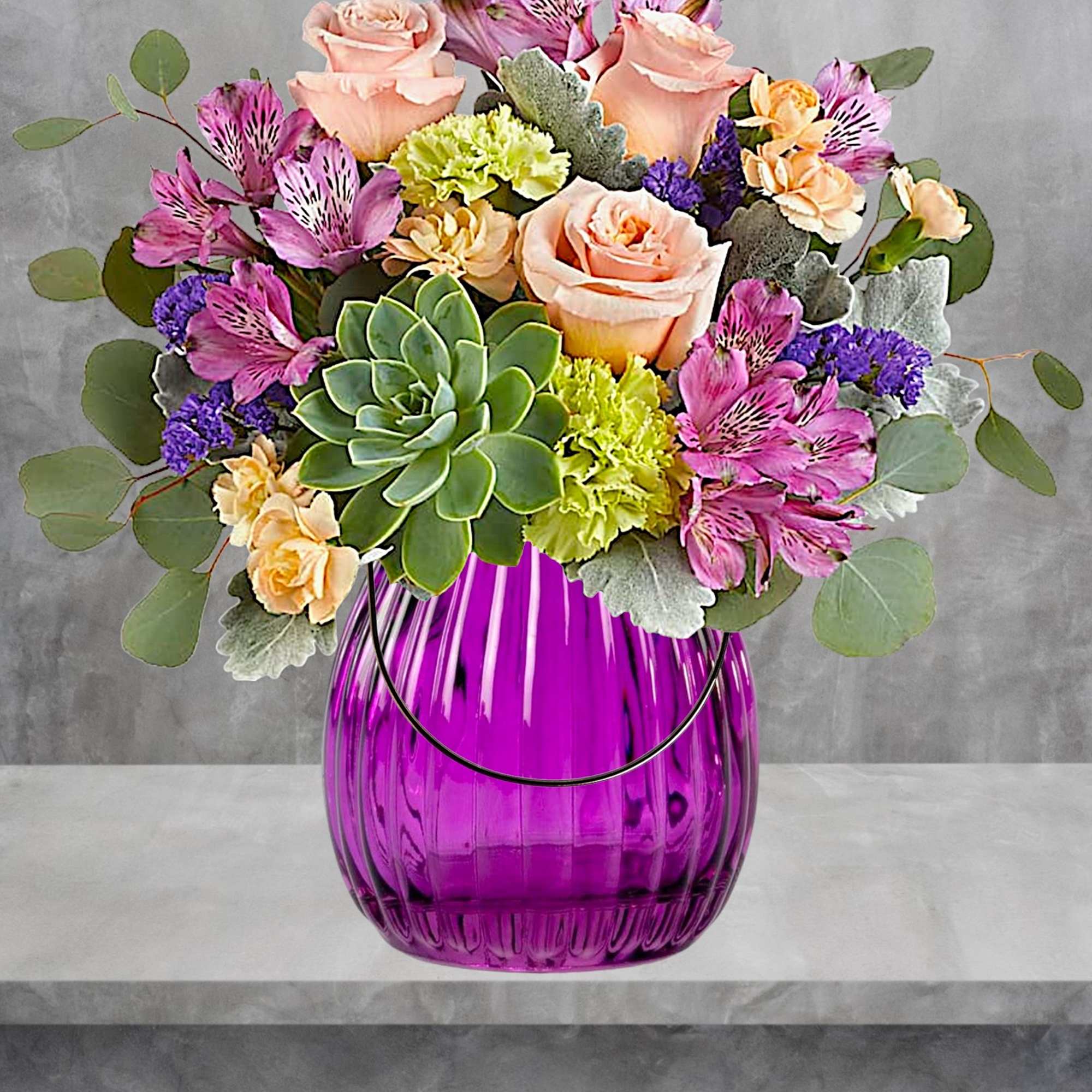 Pink roses and purple alstroemeria in a purple glass vase