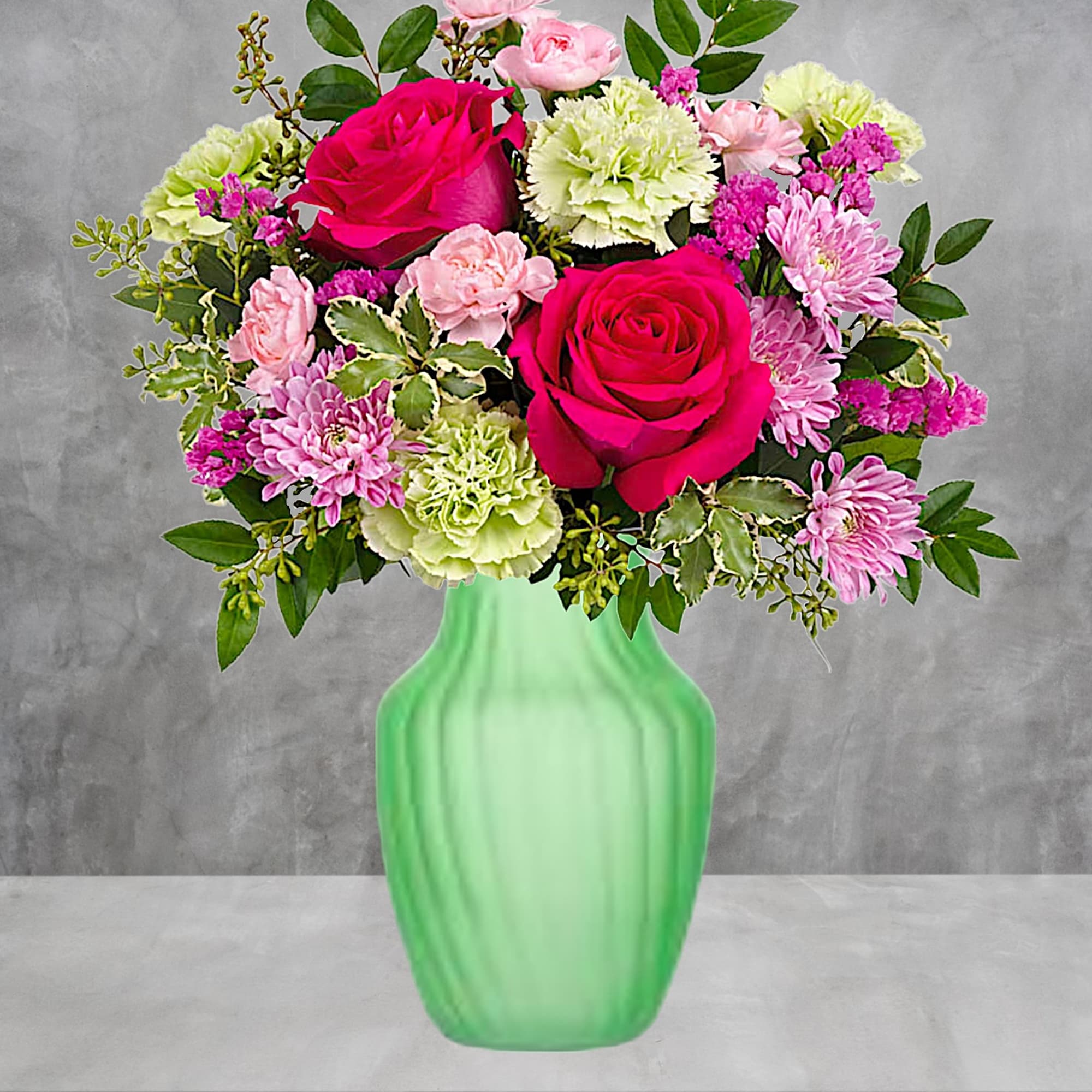 Pink and green flower arrangement in a green vase