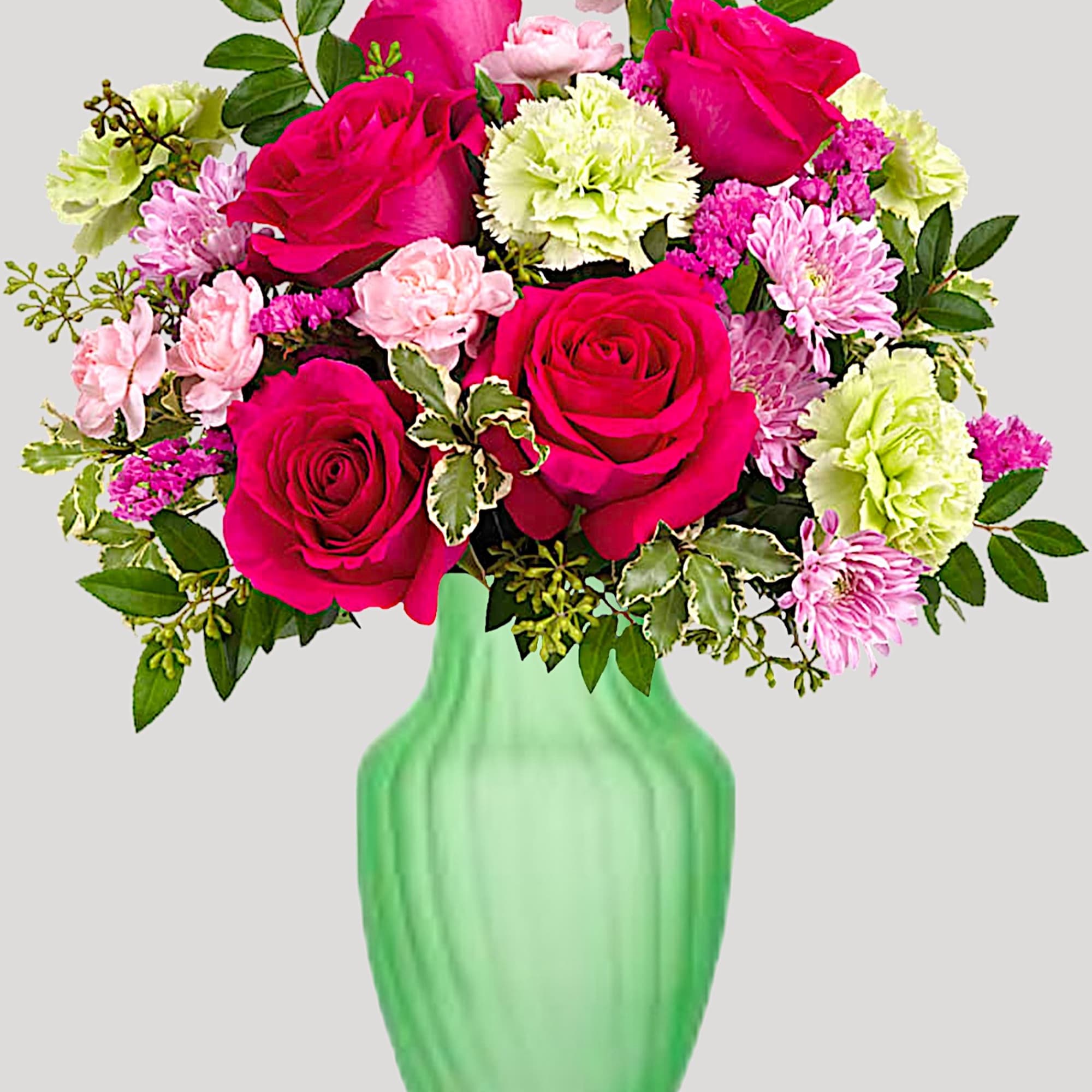 Pink and lime floral bouquet in a green vase