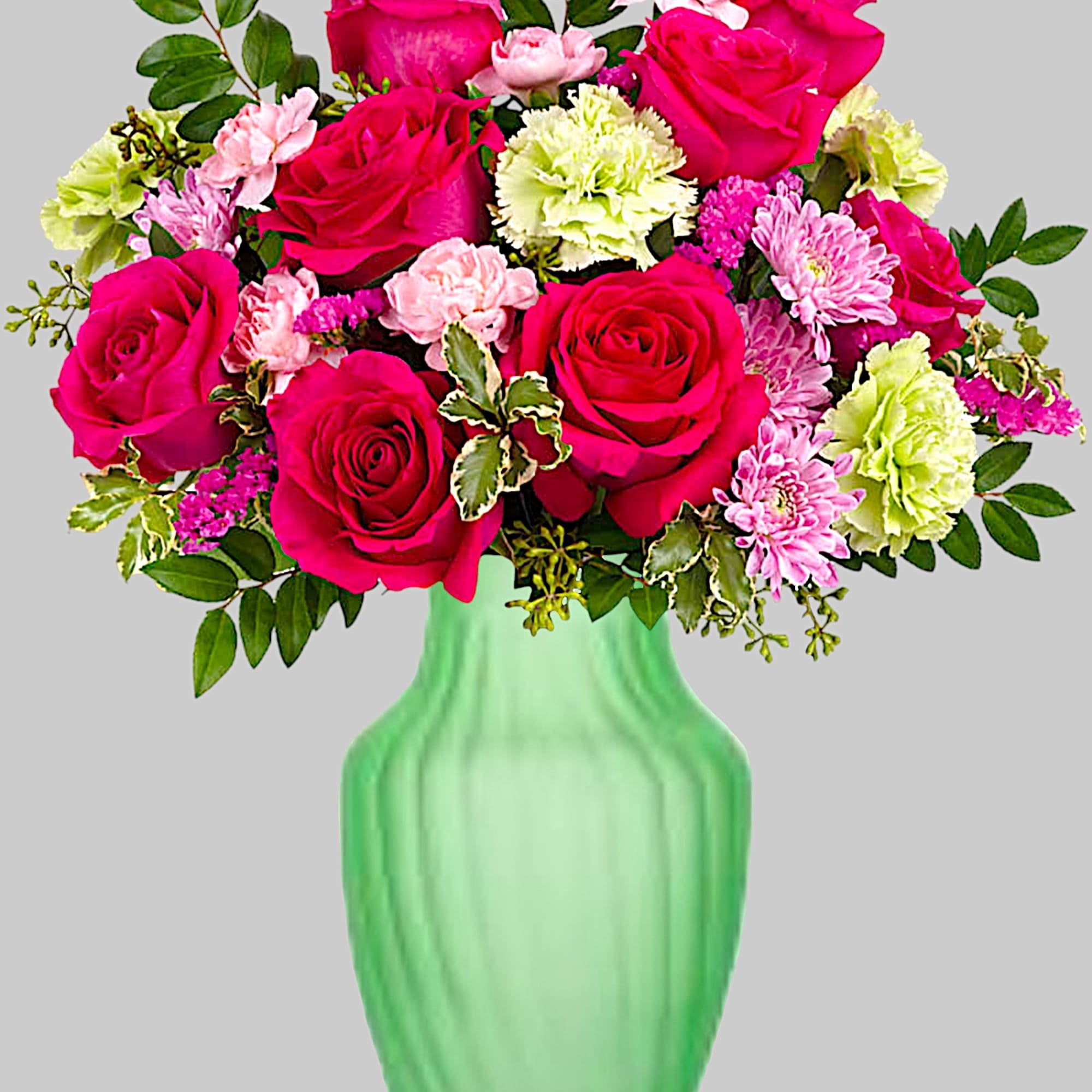 Bouquet of pink roses and carnations in a green vase