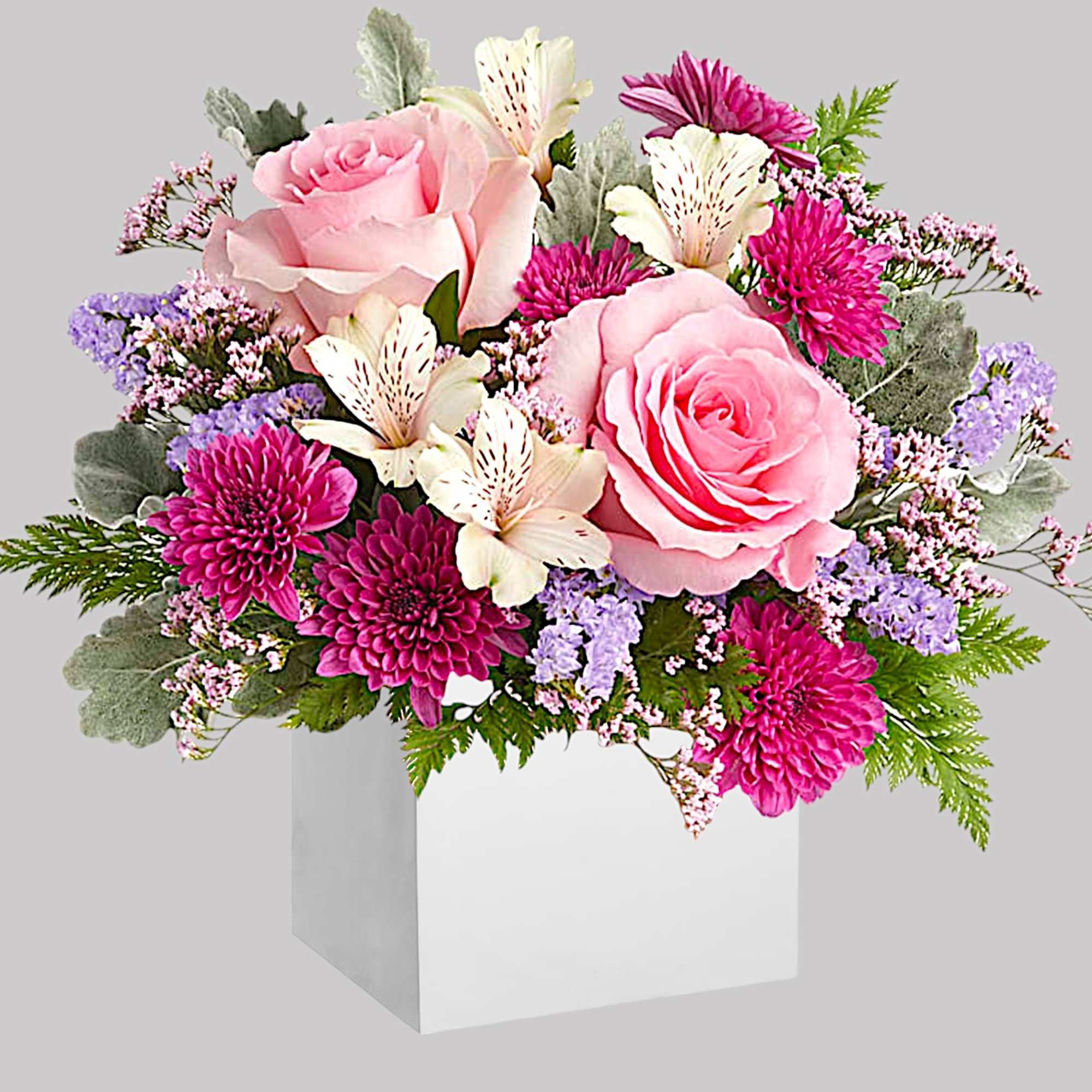 Pink roses and magenta mums in a white box with lavender filler