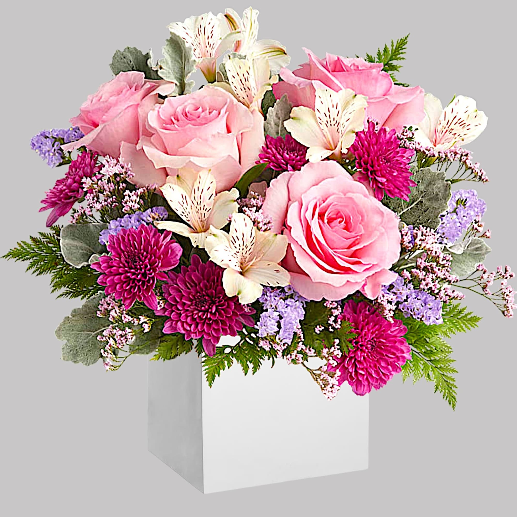 Pink roses and white alstroemeria in a white box vase