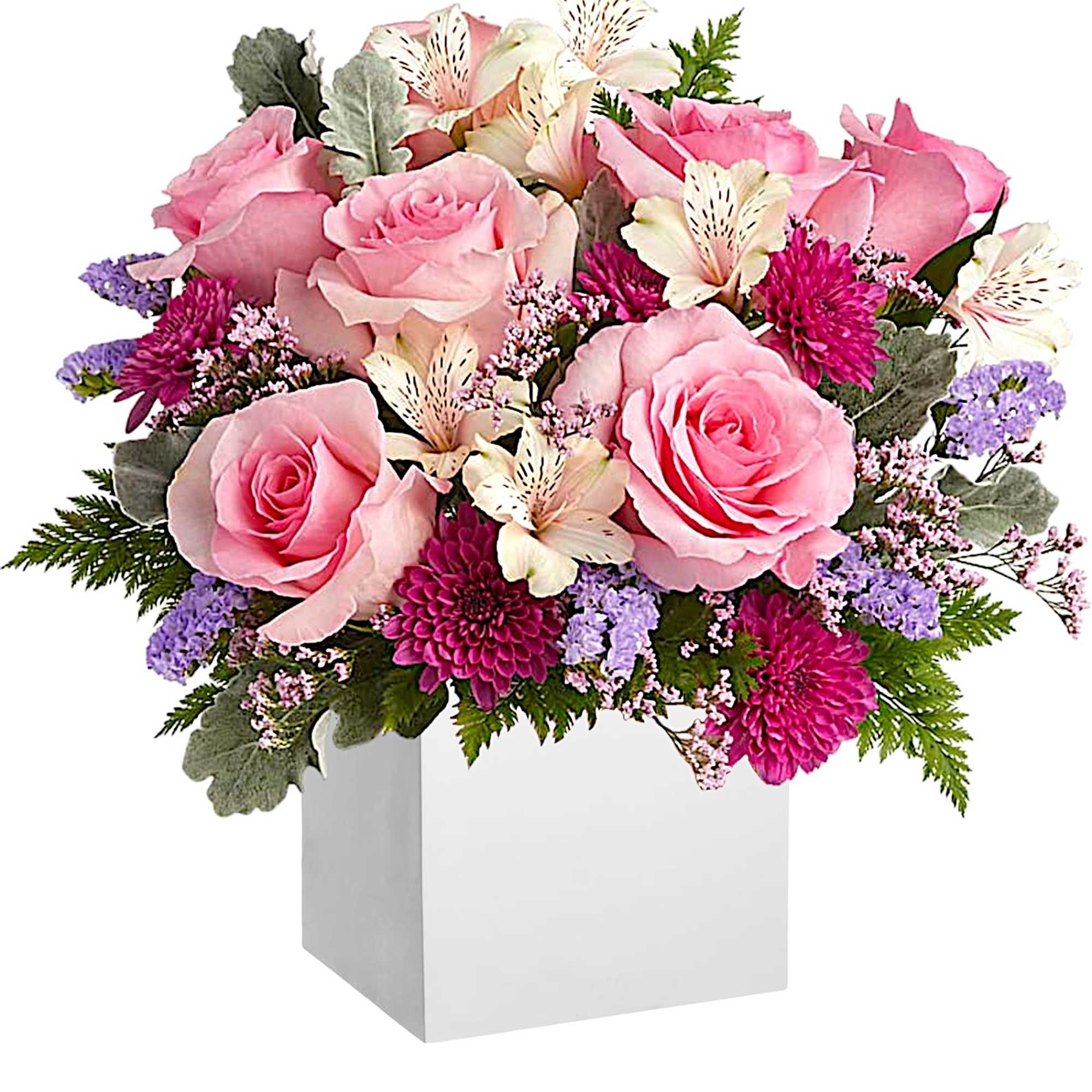 Pink roses and mixed blooms arranged in a white box