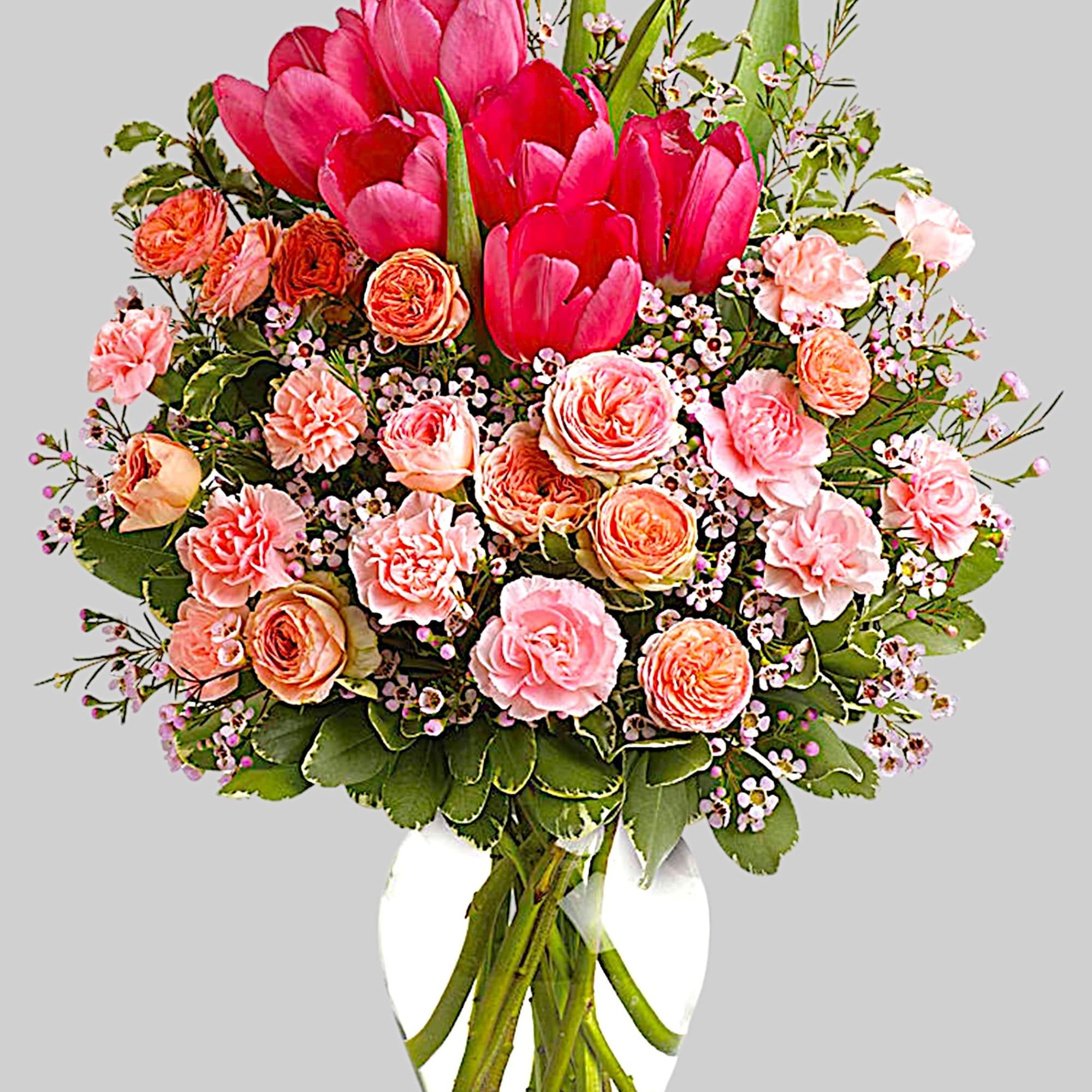 Pink tulips and peach roses in a clear glass vase, photo 4 of 4