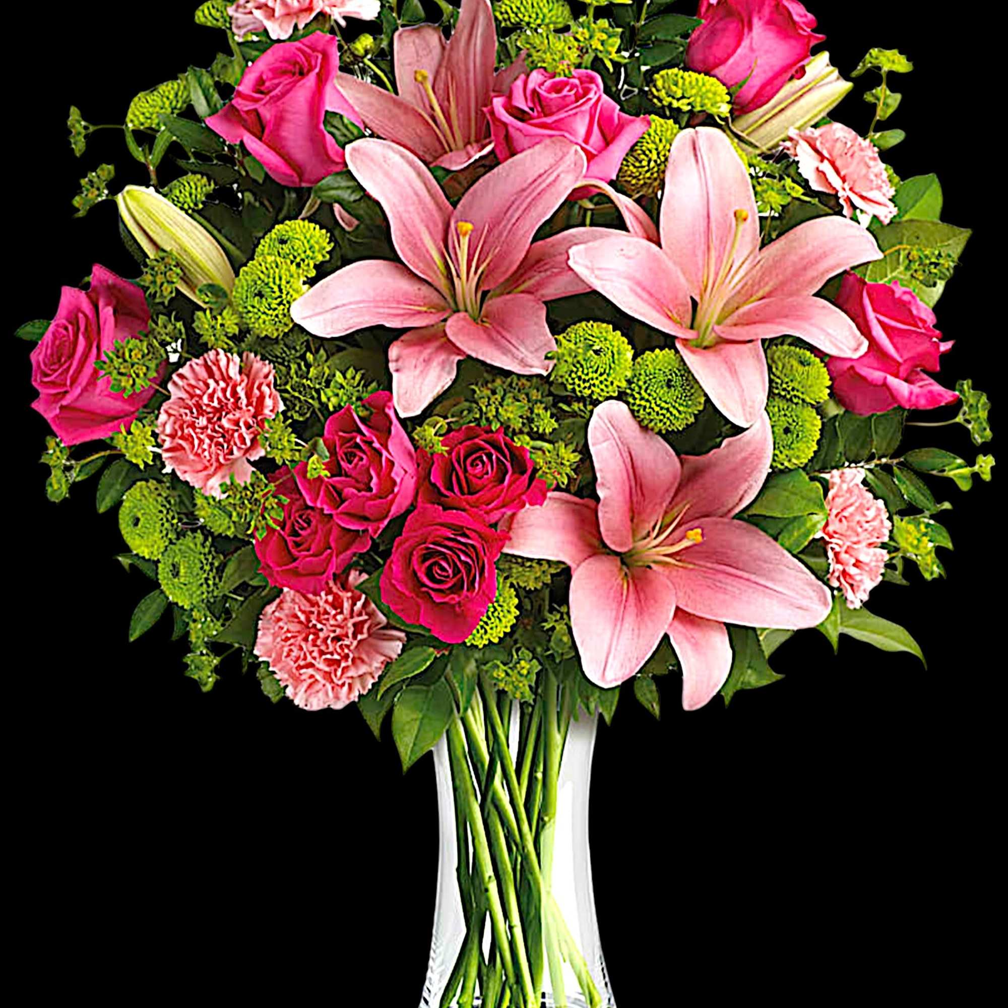 Pink lilies, roses, and carnations in a clear glass vase, photo 5 of 5