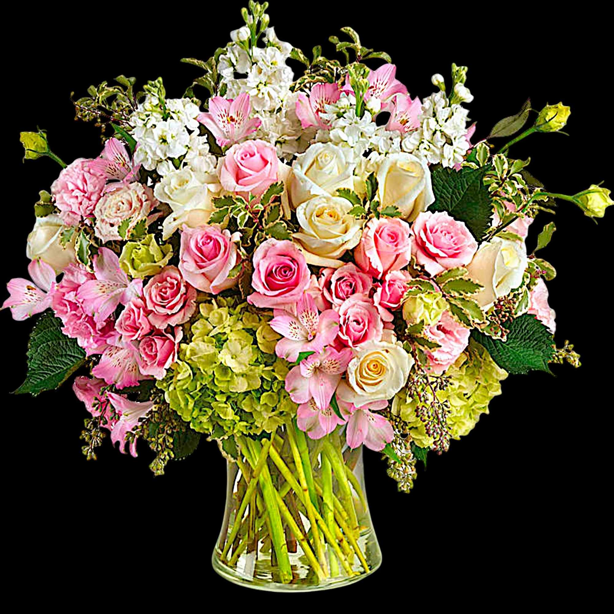 Pink and white roses with alstroemeria in a clear glass vase