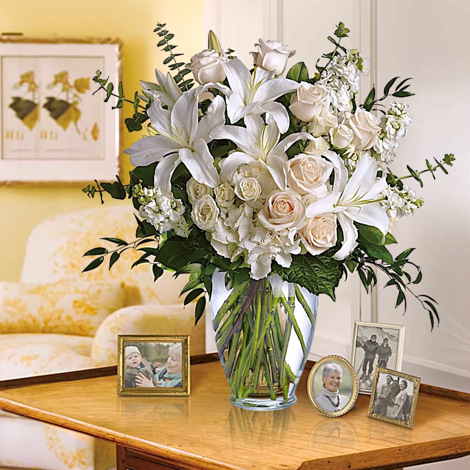 White lilies and roses arranged in a clear glass vase, photo 2 of 5