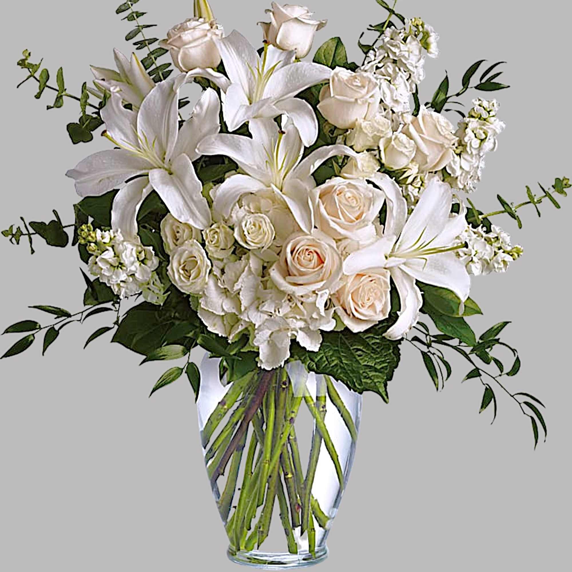 White lilies and roses arranged in a clear glass vase, photo 5 of 5