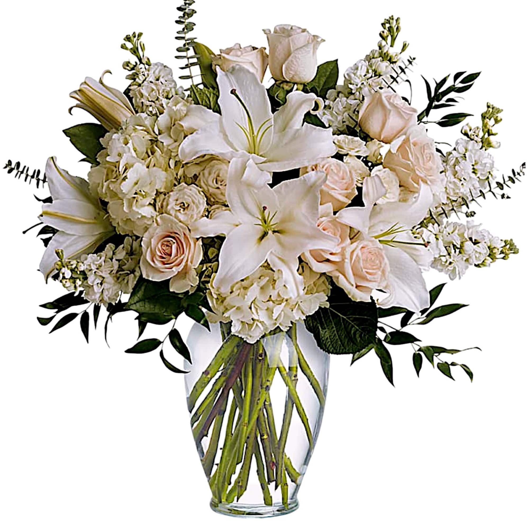 White lilies and pale roses in a clear glass vase