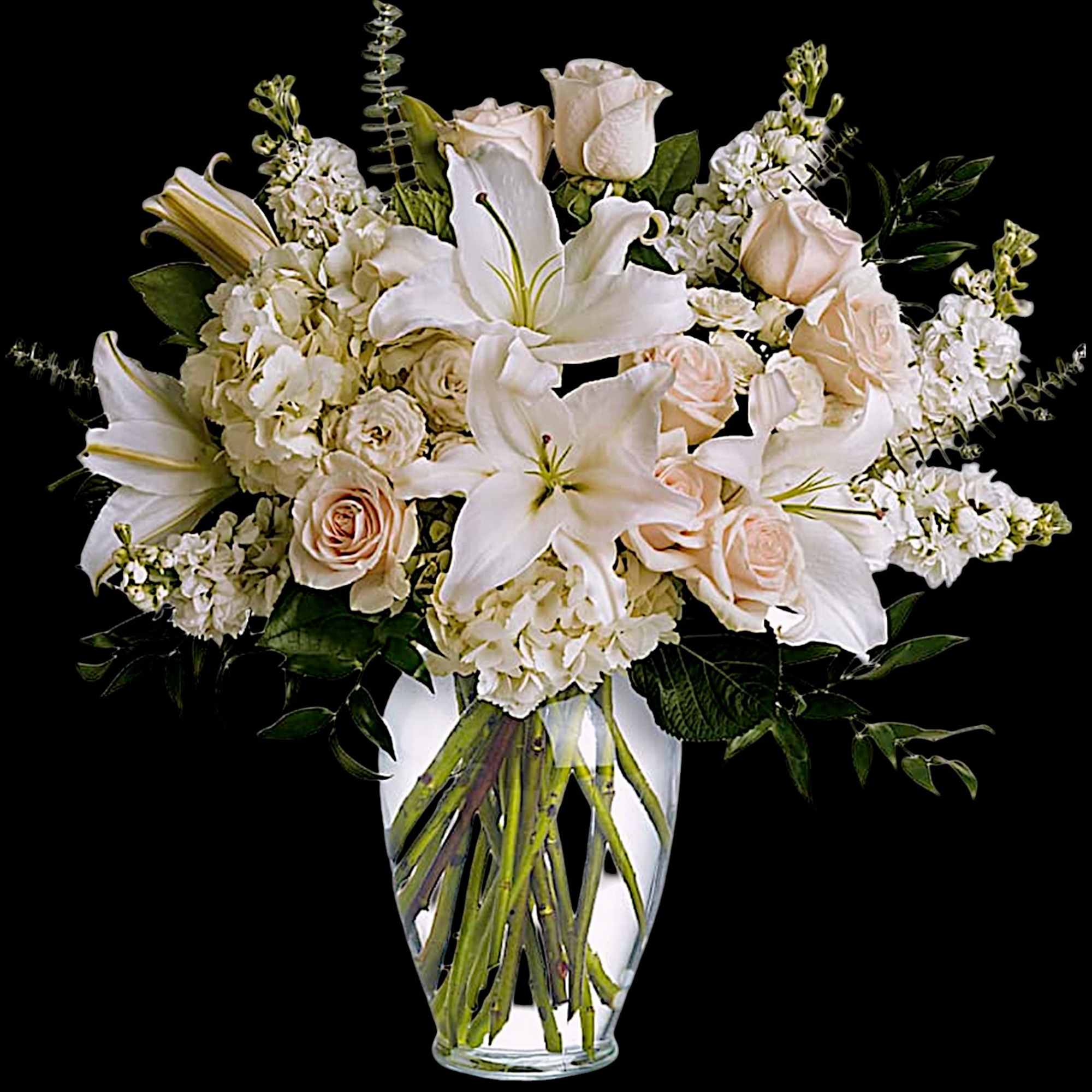 White lilies and pale roses arranged in a clear glass vase, photo 4 of 5