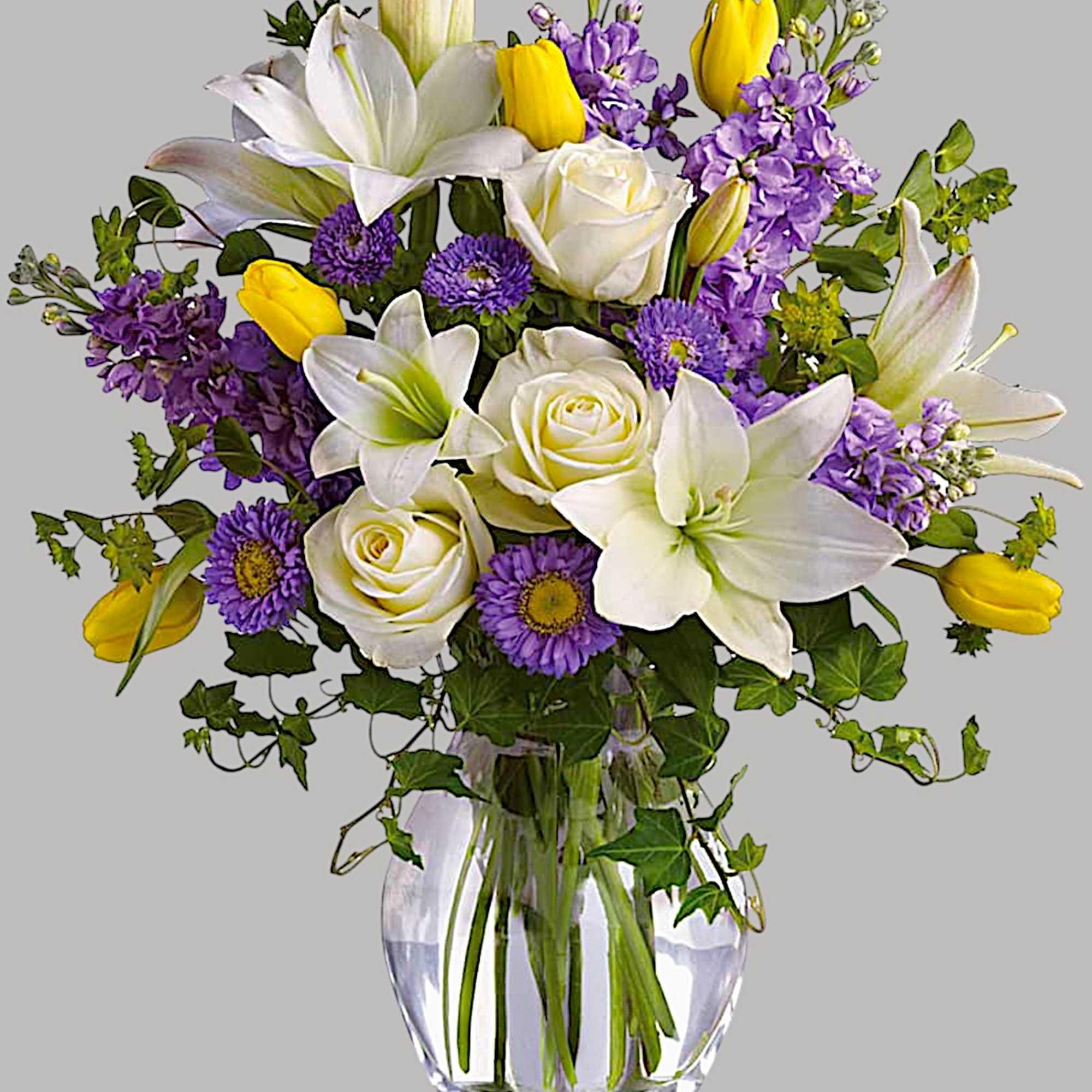 Bouquet of white lilies, roses, purple flowers, and yellow tulips in a glass vase, photo 5 of 5