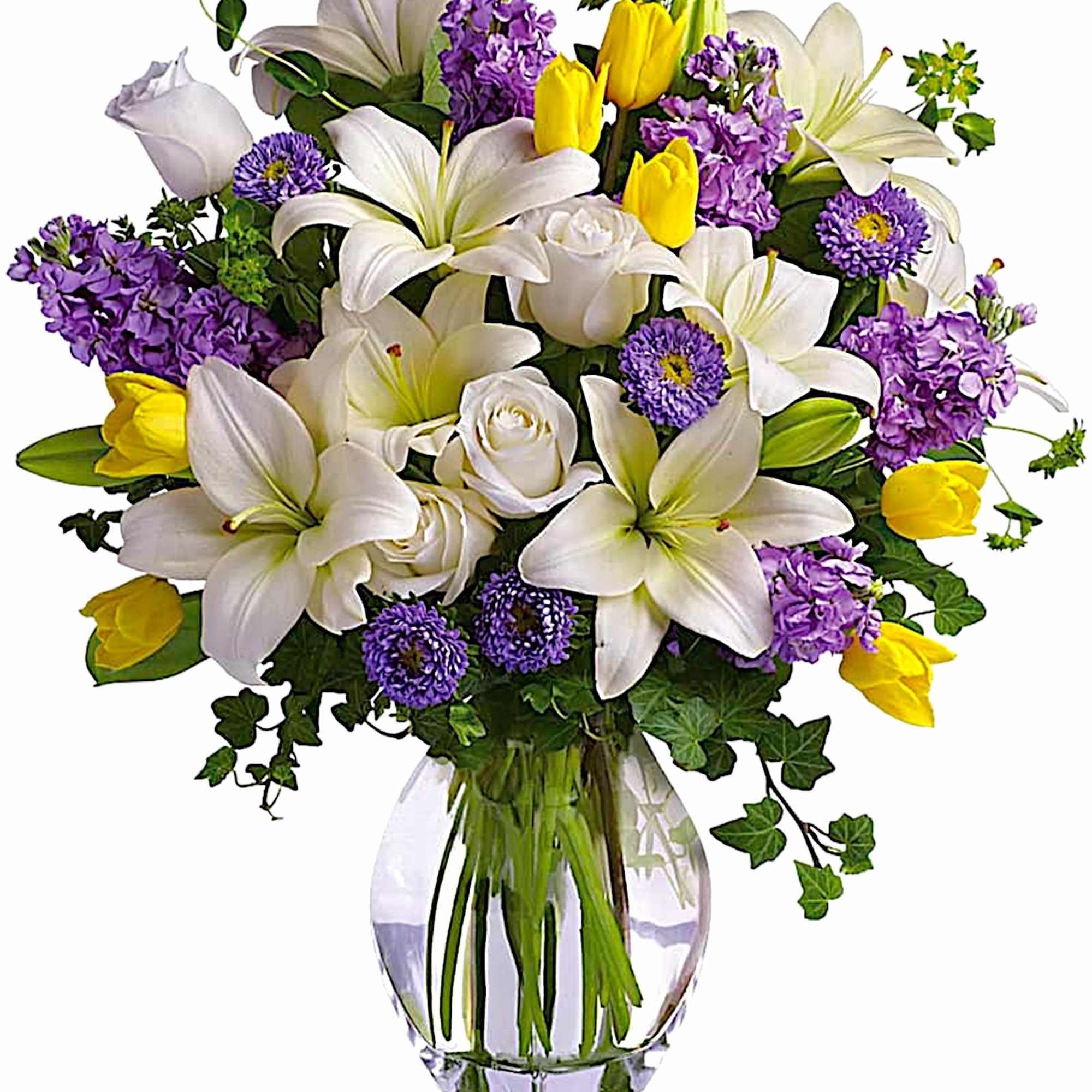 Bouquet of white lilies, purple flowers, and yellow tulips in a glass vase