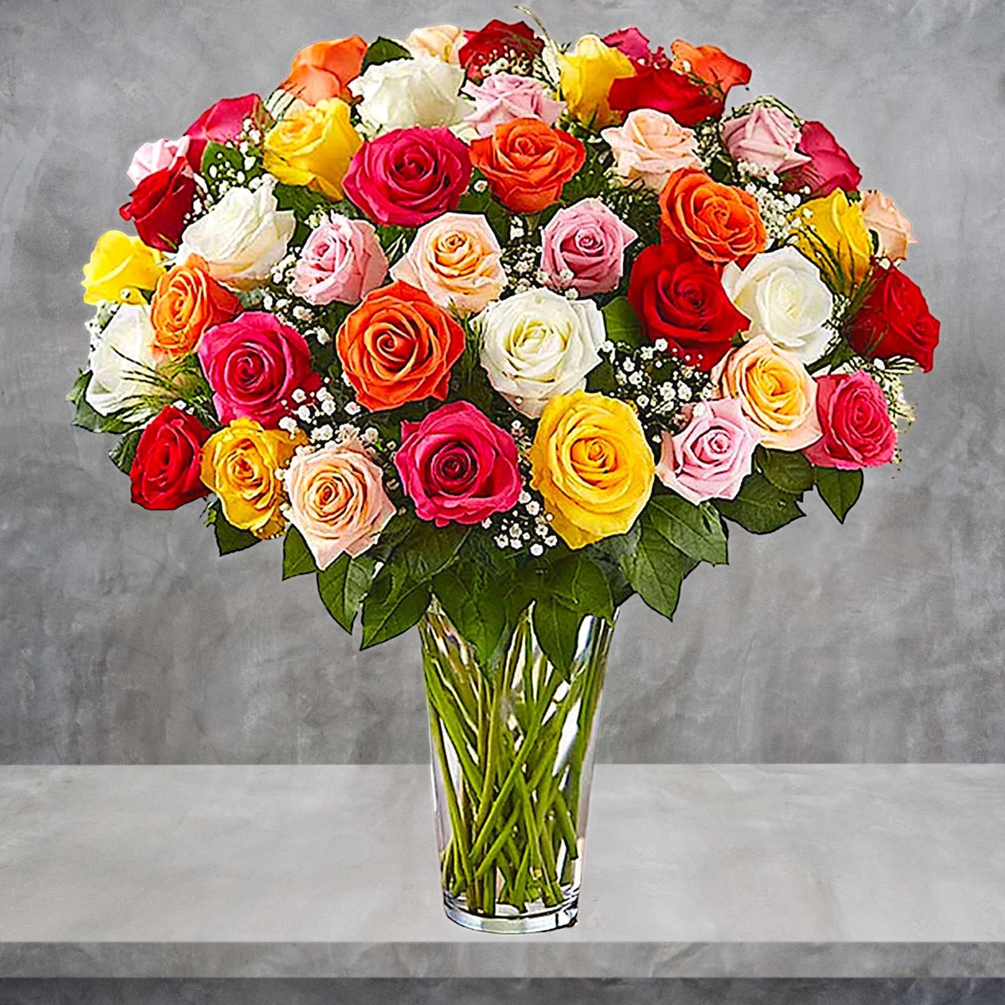 Mixed roses in a clear glass vase