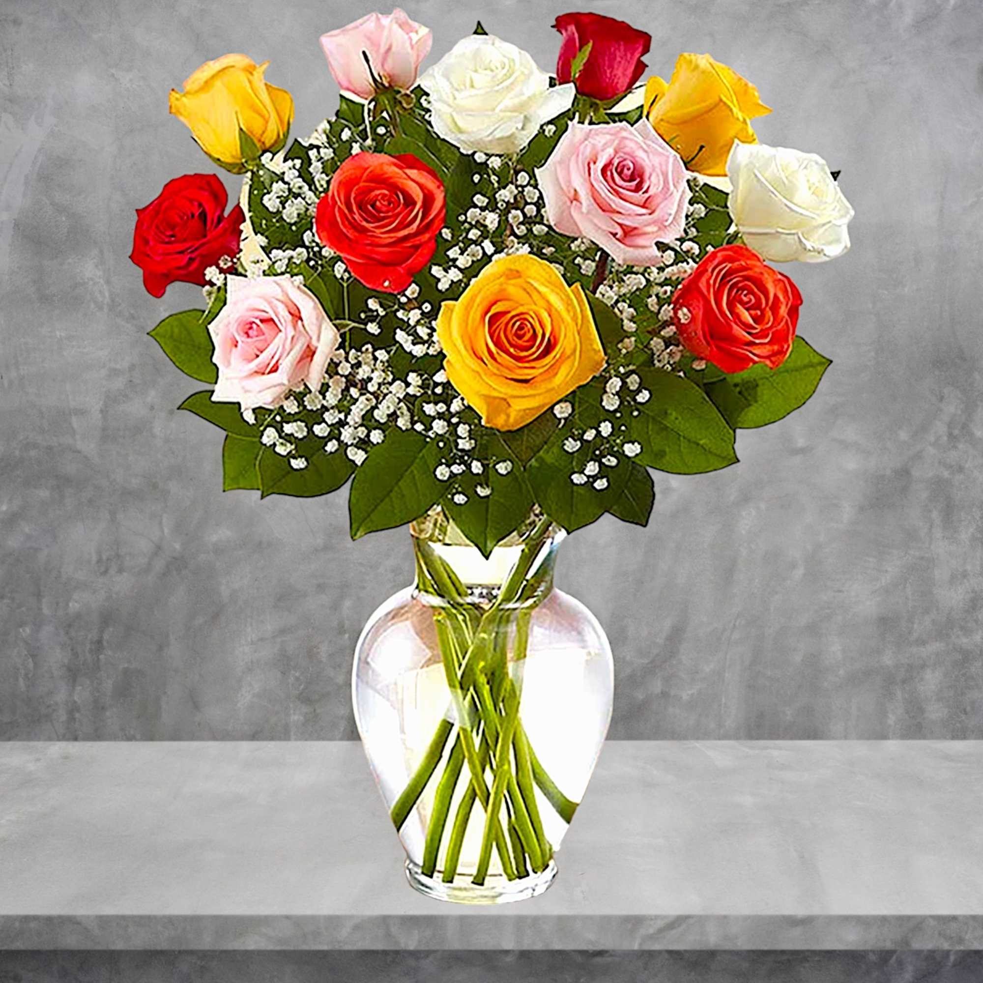 Bouquet of multicolored roses in a clear glass vase