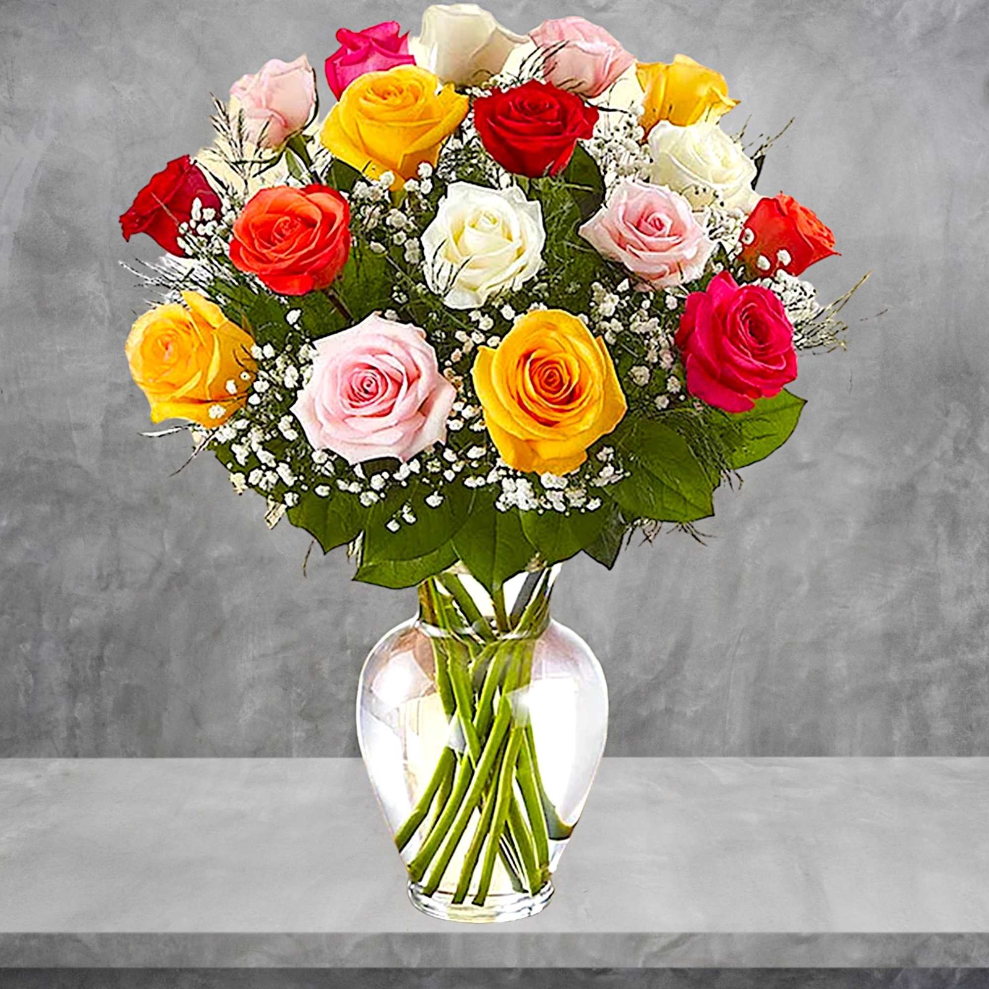 Mixed roses in a clear glass vase with baby's breath
