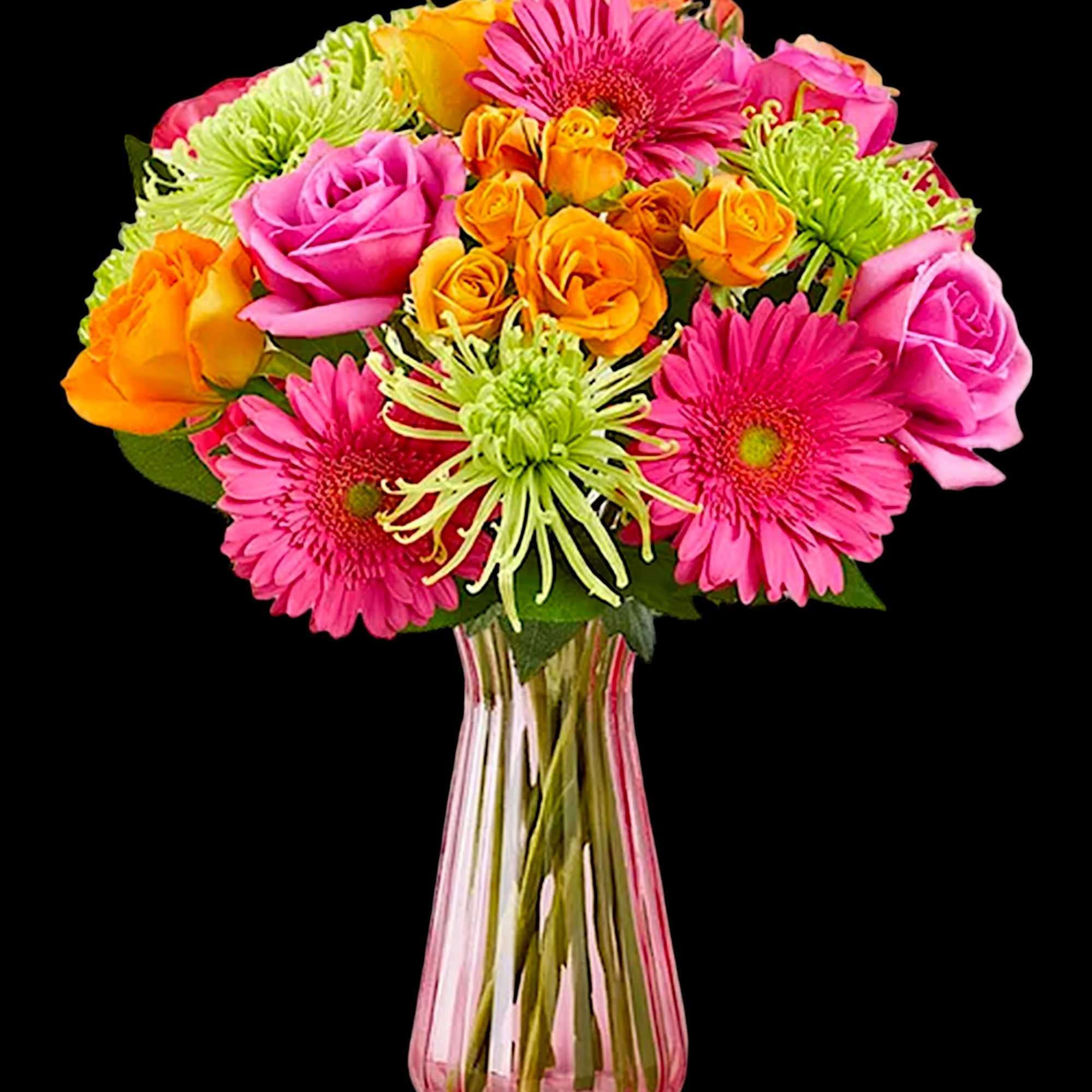 Bright mixed bouquet of pink and orange flowers in a clear glass vase
