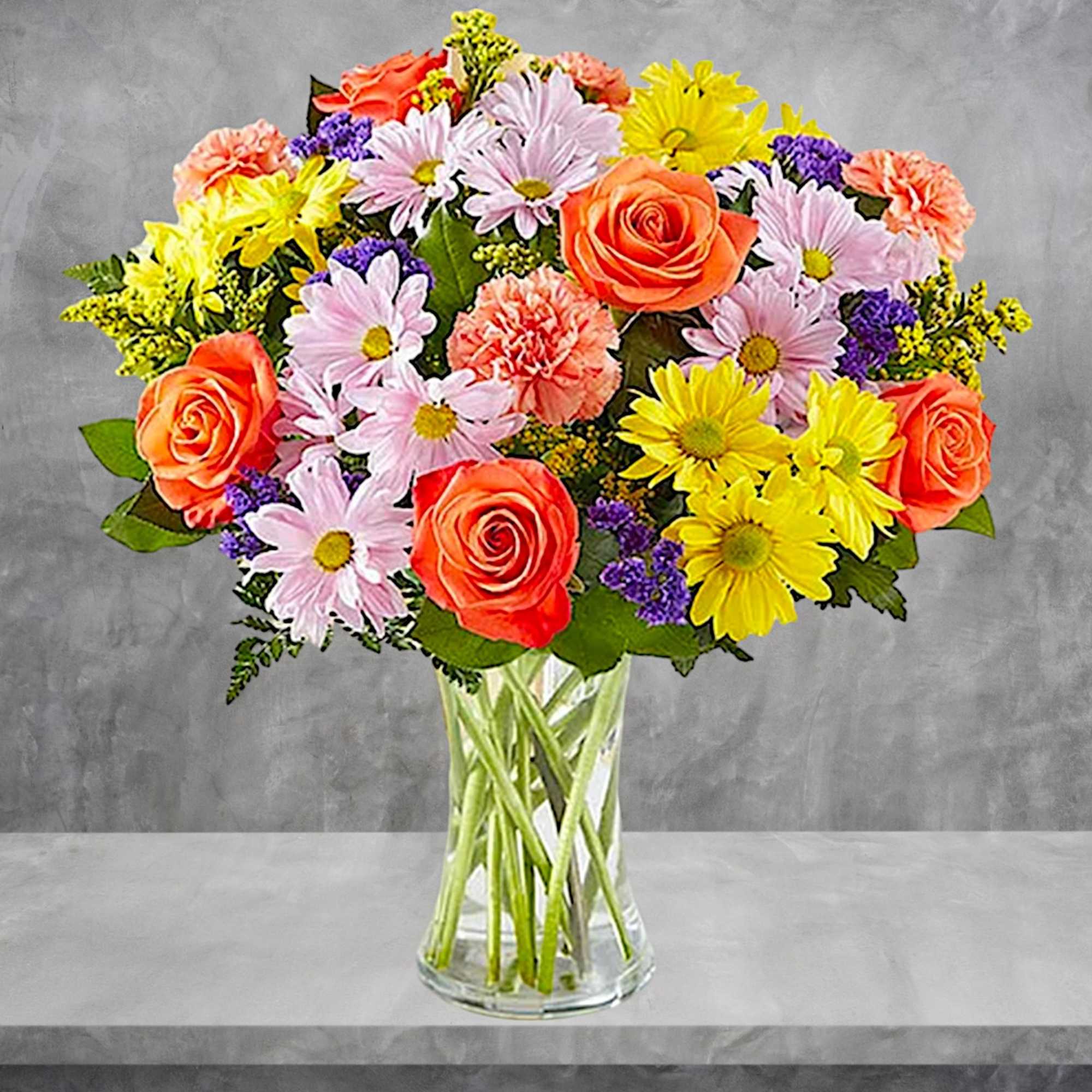 Mixed bouquet of roses, daisies, and carnations in a clear glass vase, photo 3 of 5