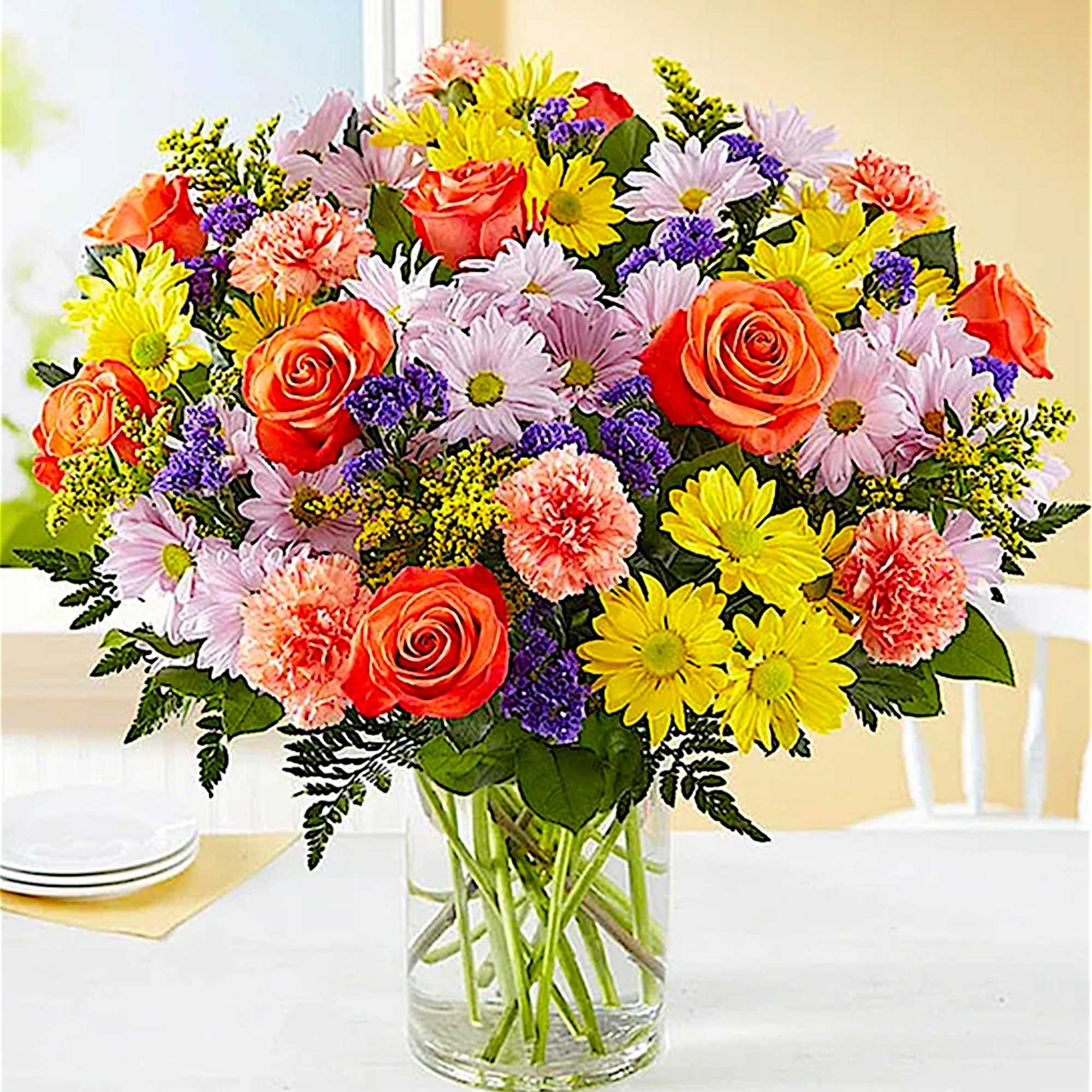 Mixed bouquet of roses, daisies, and carnations in a clear glass vase, photo 2 of 5