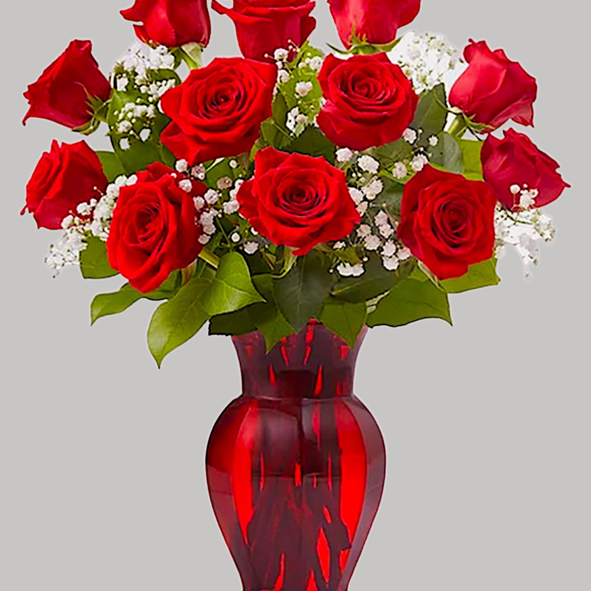Red roses arranged in a red glass vase with white filler flowers, photo 5 of 5